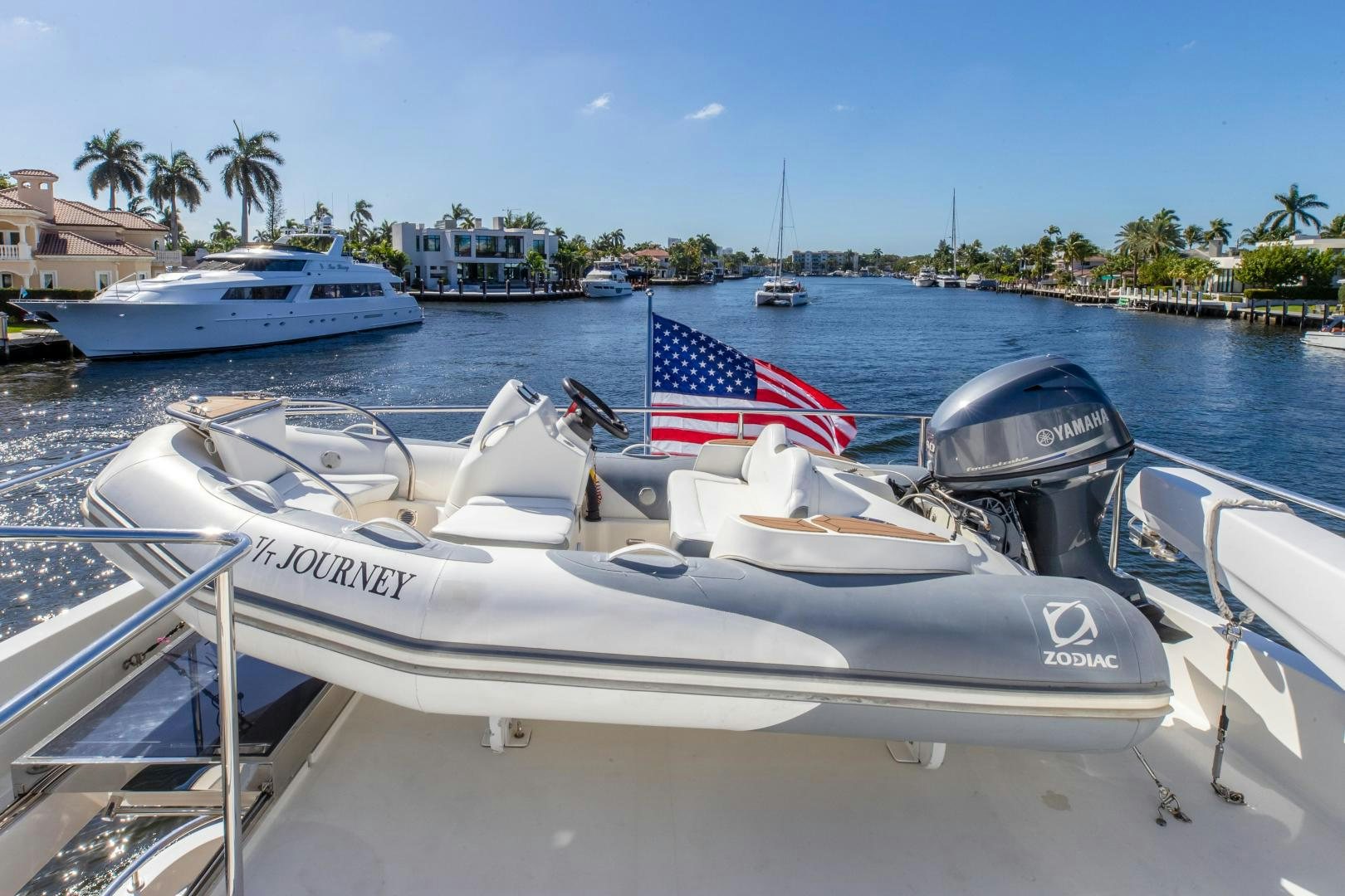 a boat with a flag on the front aboard JOURNEY Yacht for Sale