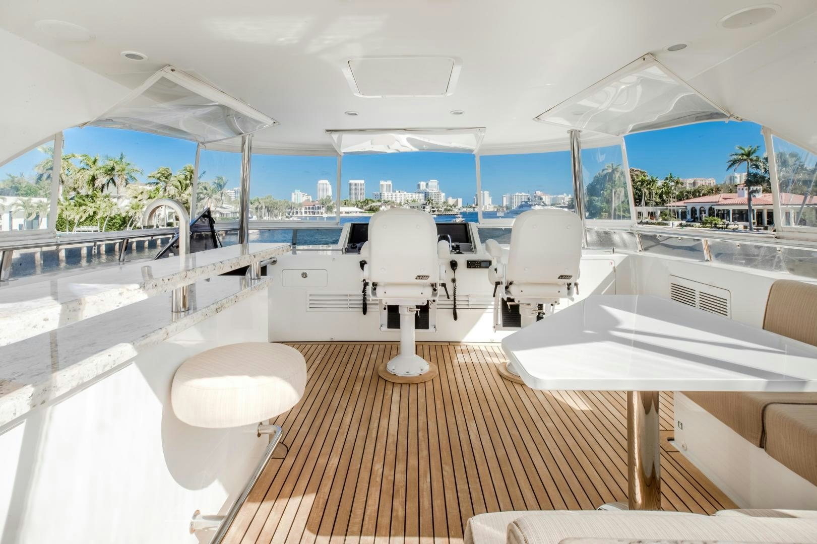 a room with a table chairs and a large window aboard JOURNEY Yacht for Sale