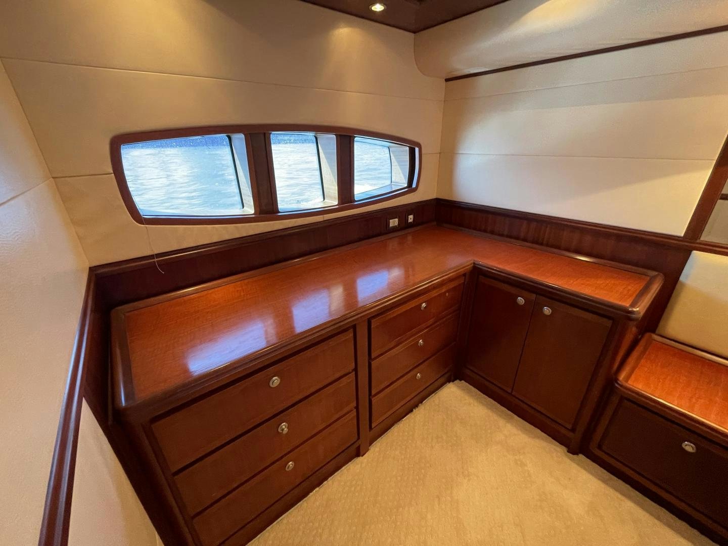 a room with a dresser and a television aboard ONIX Yacht for Sale