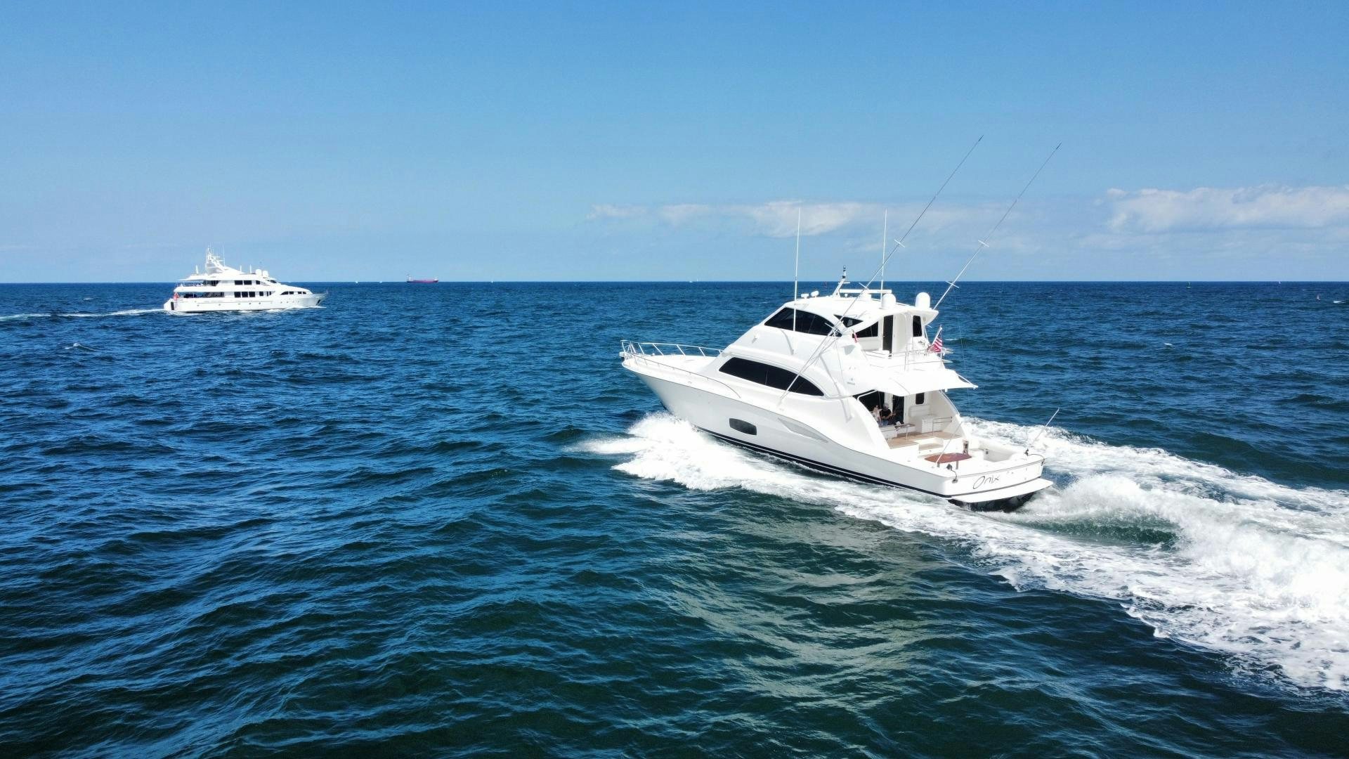 a white boat on the water aboard ONIX Yacht for Sale