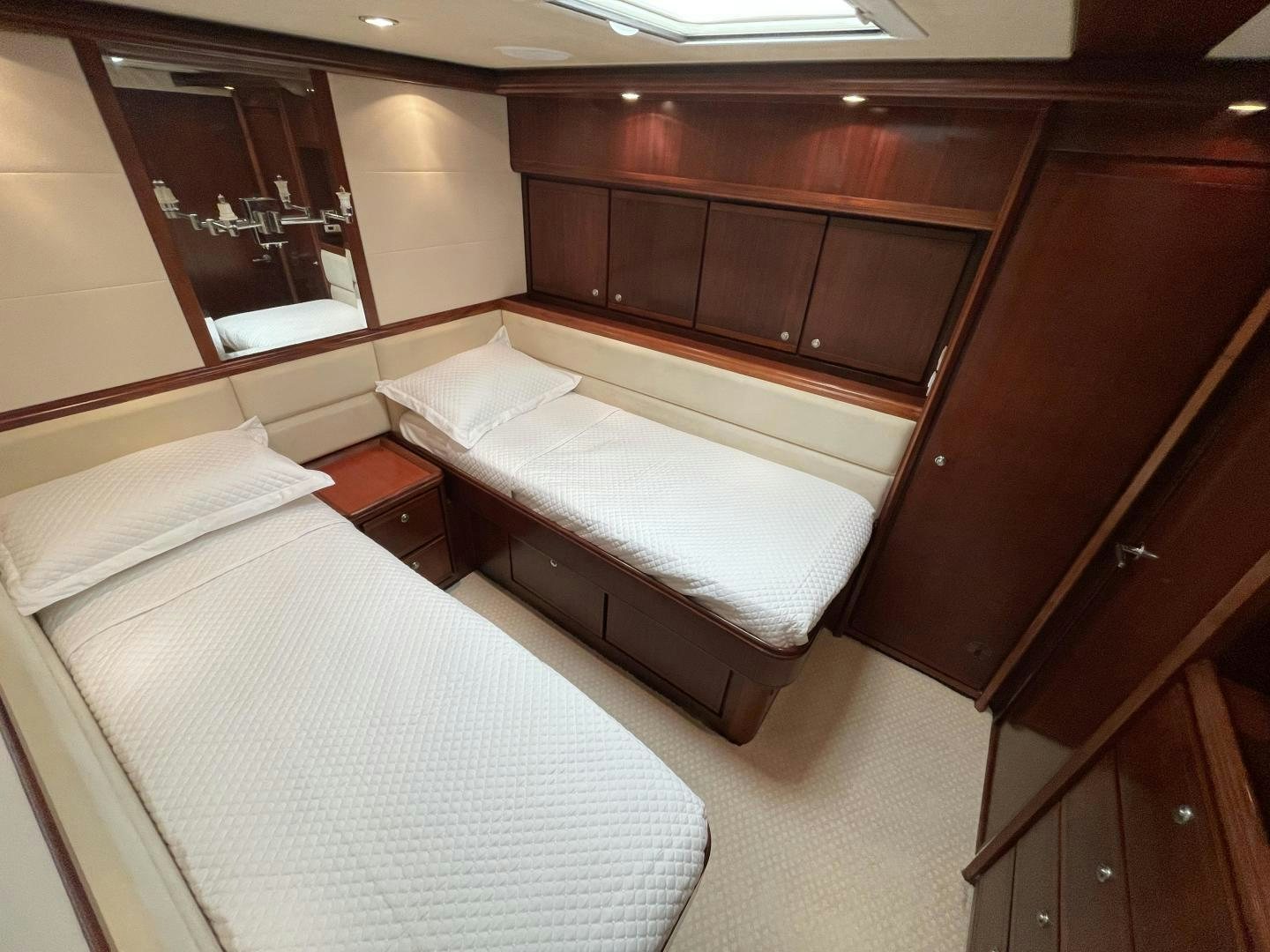 a room with a bed and a mirror aboard ONIX Yacht for Sale