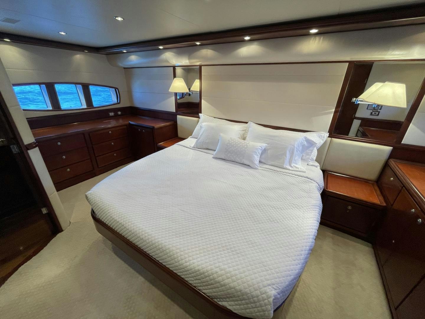 a bed with white sheets aboard ONIX Yacht for Sale