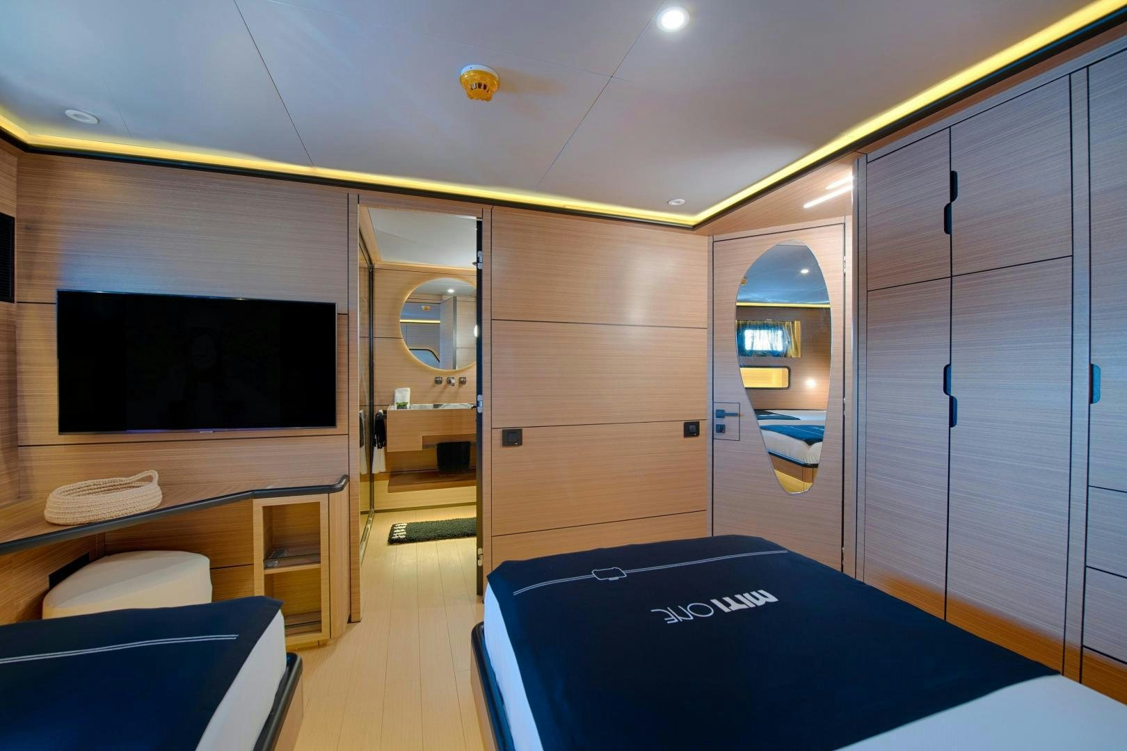a room with a tv and a table aboard MITI ONE Yacht for Sale