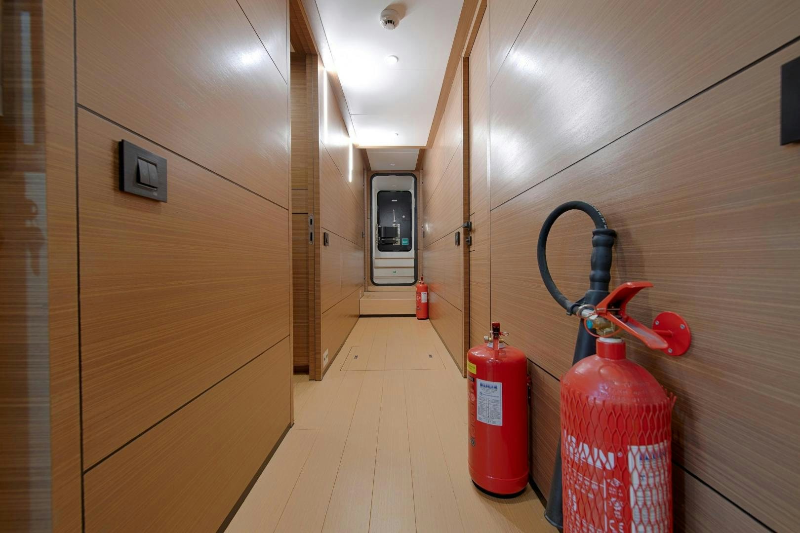 a room with a red fire extinguisher and a red fire extinguisher in aboard MITI ONE Yacht for Sale