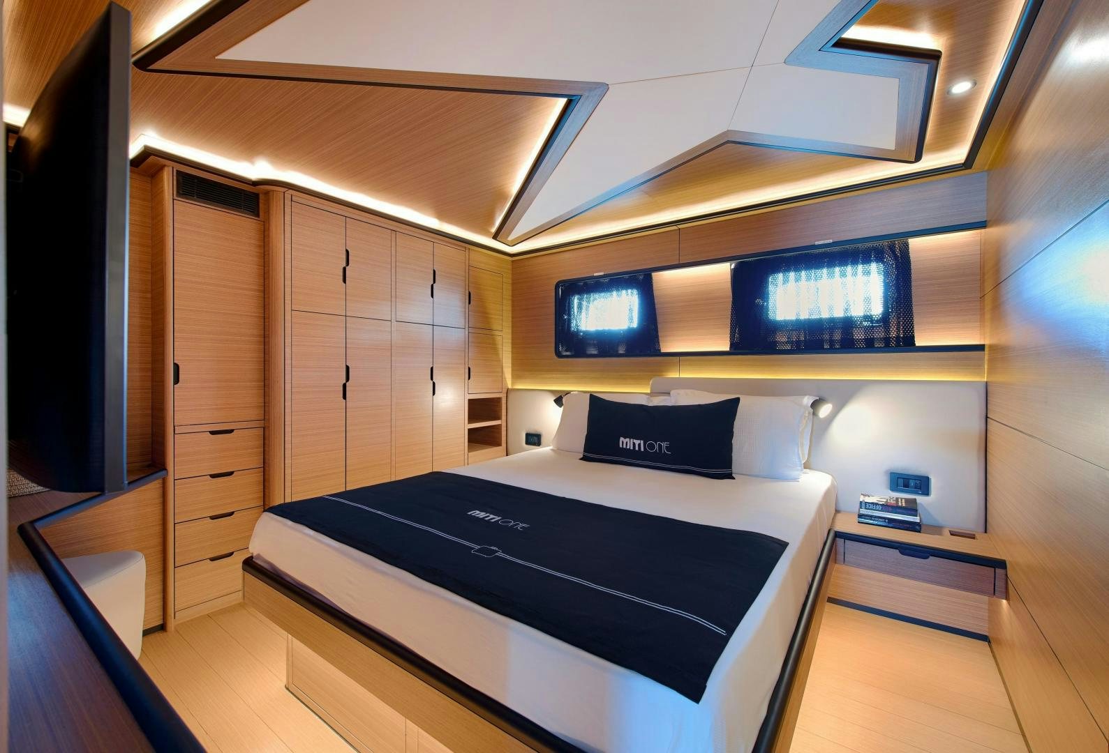 a room with a bed and a desk aboard MITI ONE Yacht for Sale