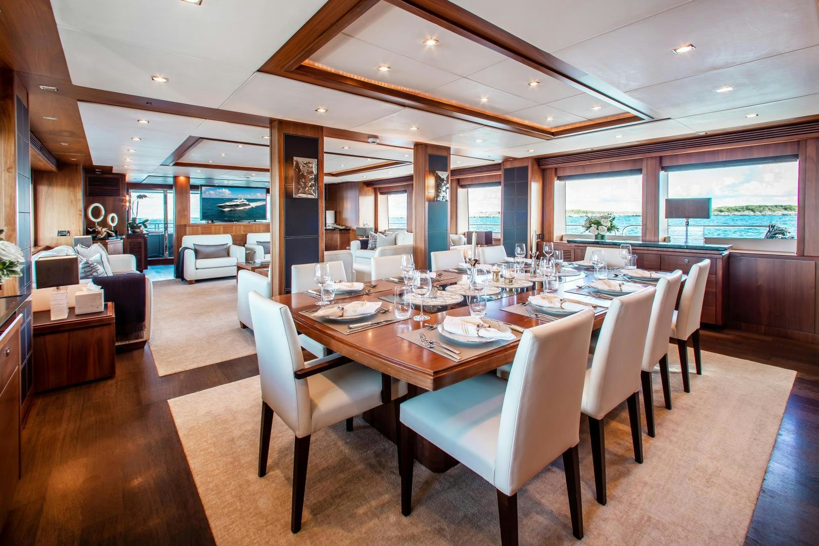 a large dining table in a room aboard ACACIA Yacht for Sale