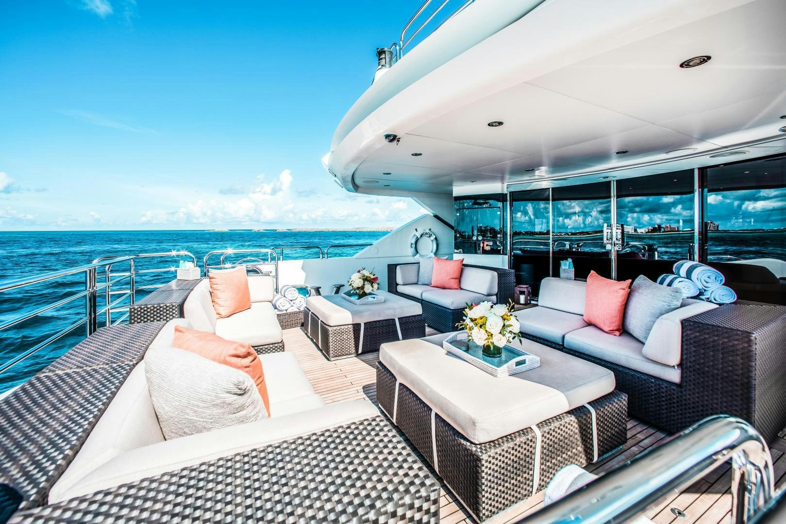 a large white lounge chair next to a large body of water aboard ACACIA Yacht for Sale