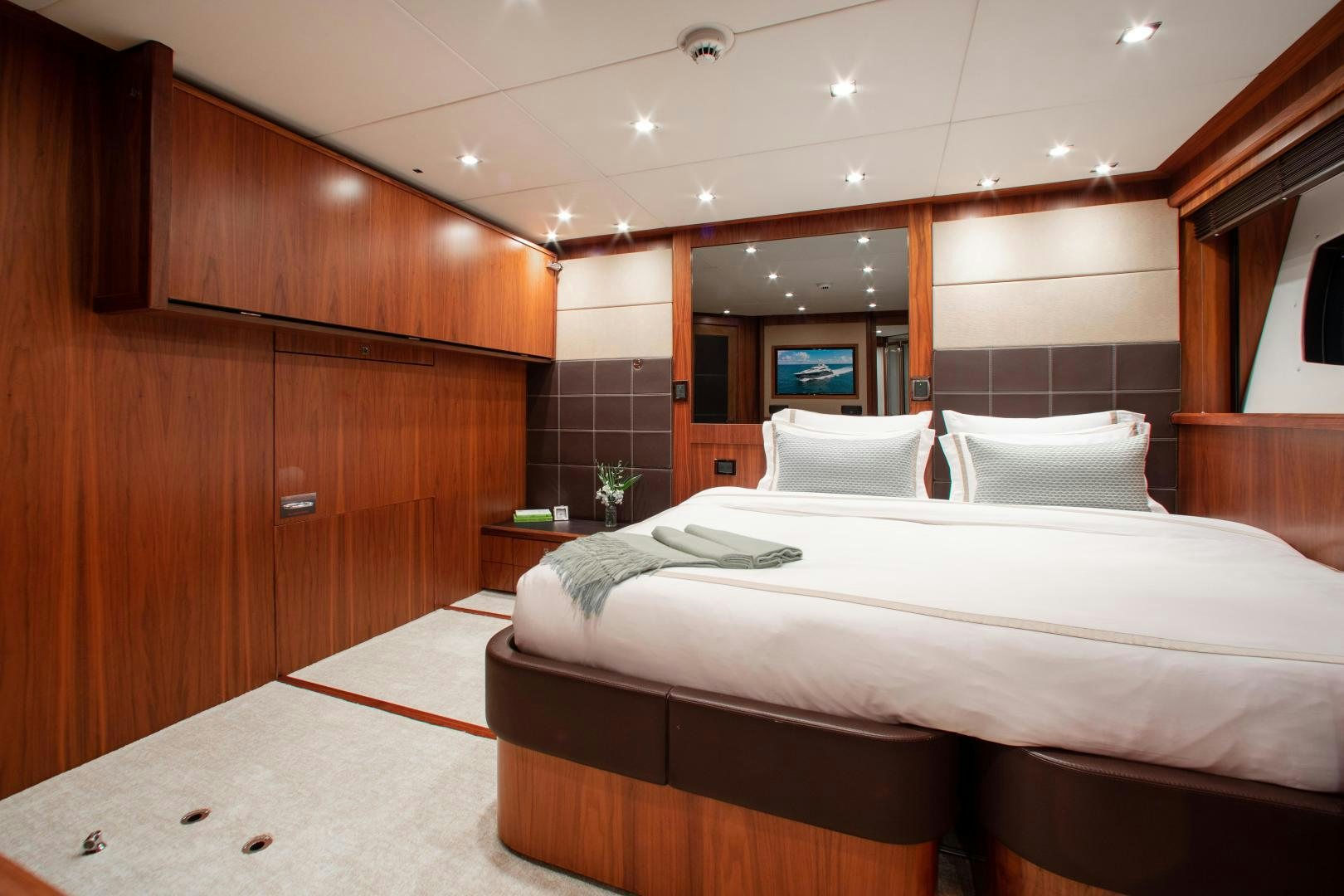 a room with a bed and a mirror aboard ACACIA Yacht for Sale
