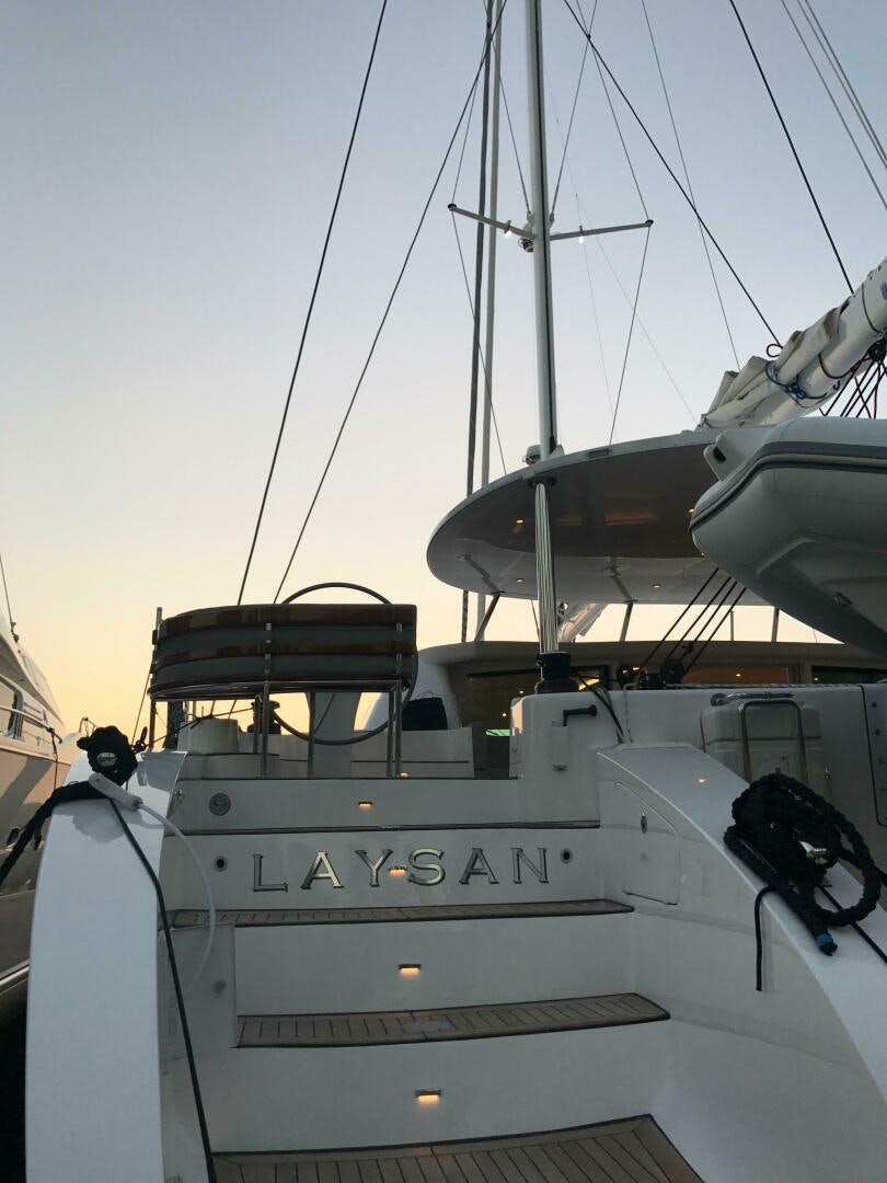 a boat with a large ship in the water aboard LAYSAN Yacht for Sale