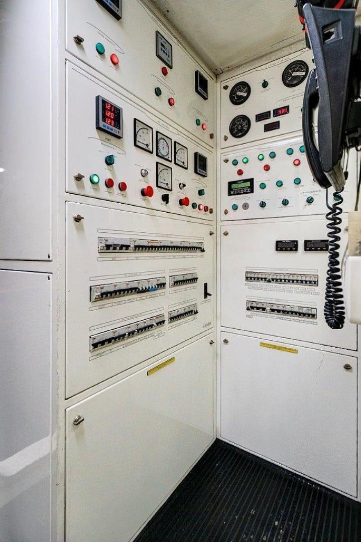 a white cabinet with buttons and knobs aboard VIVERE Yacht for Sale
