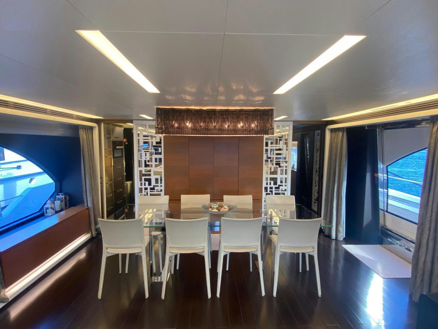 a room with a table and chairs aboard LA TACHE Yacht for Sale