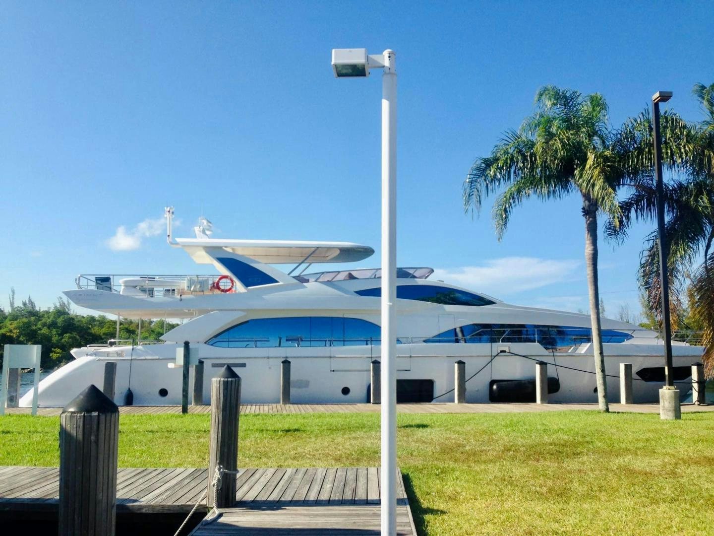 a large white boat with palm trees aboard LA TACHE Yacht for Sale