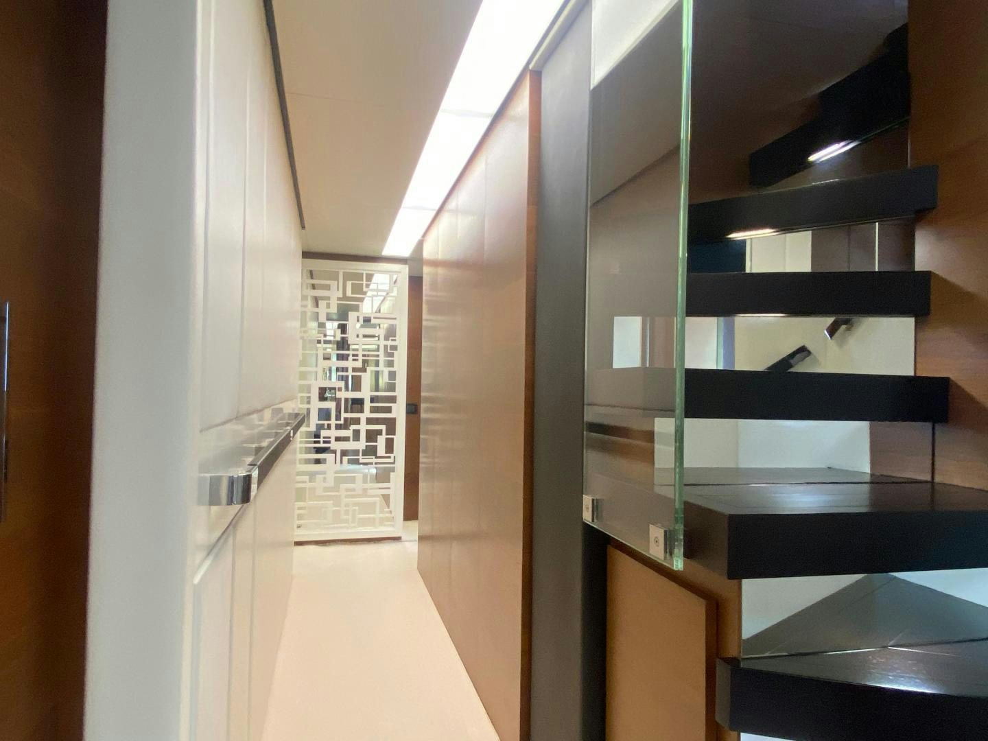 a room with a large glass display case and a black shelf aboard LA TACHE Yacht for Sale