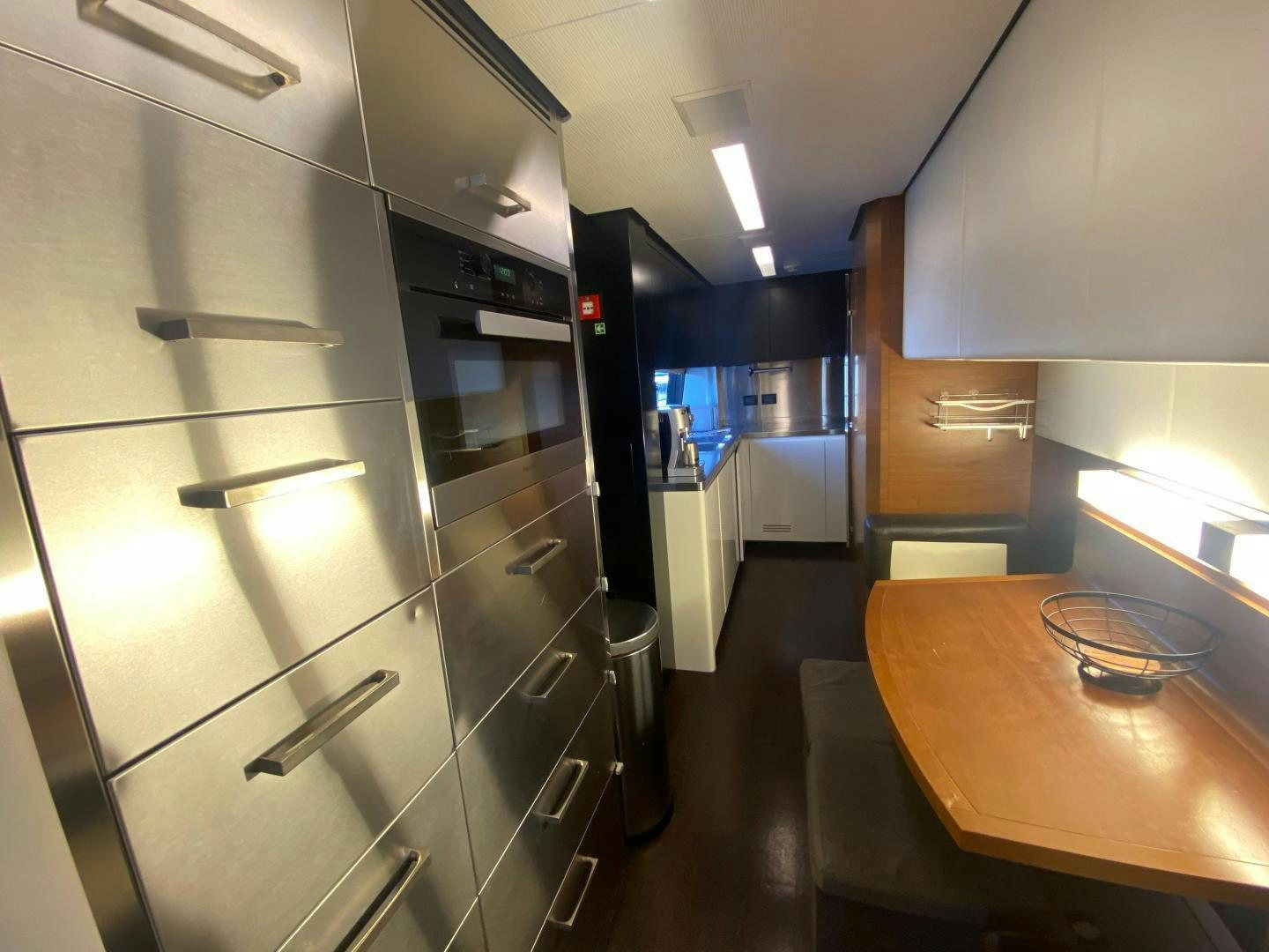 a kitchen with a stainless steel refrigerator aboard LA TACHE Yacht for Sale