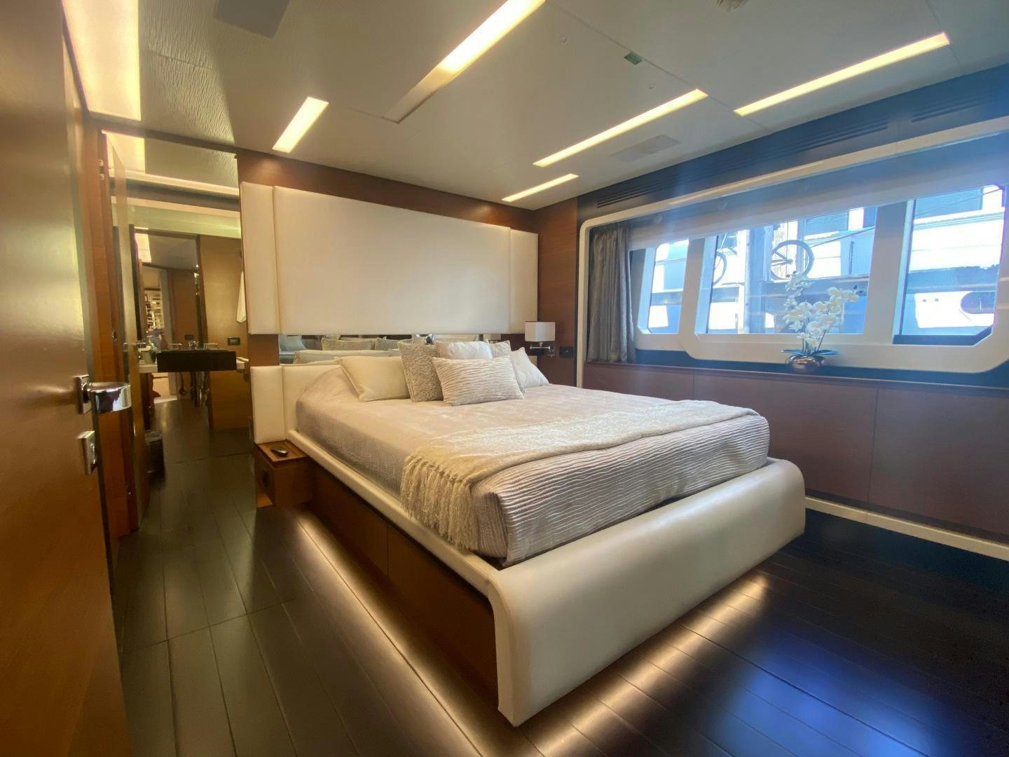 a room with a bed and a window aboard LA TACHE Yacht for Sale
