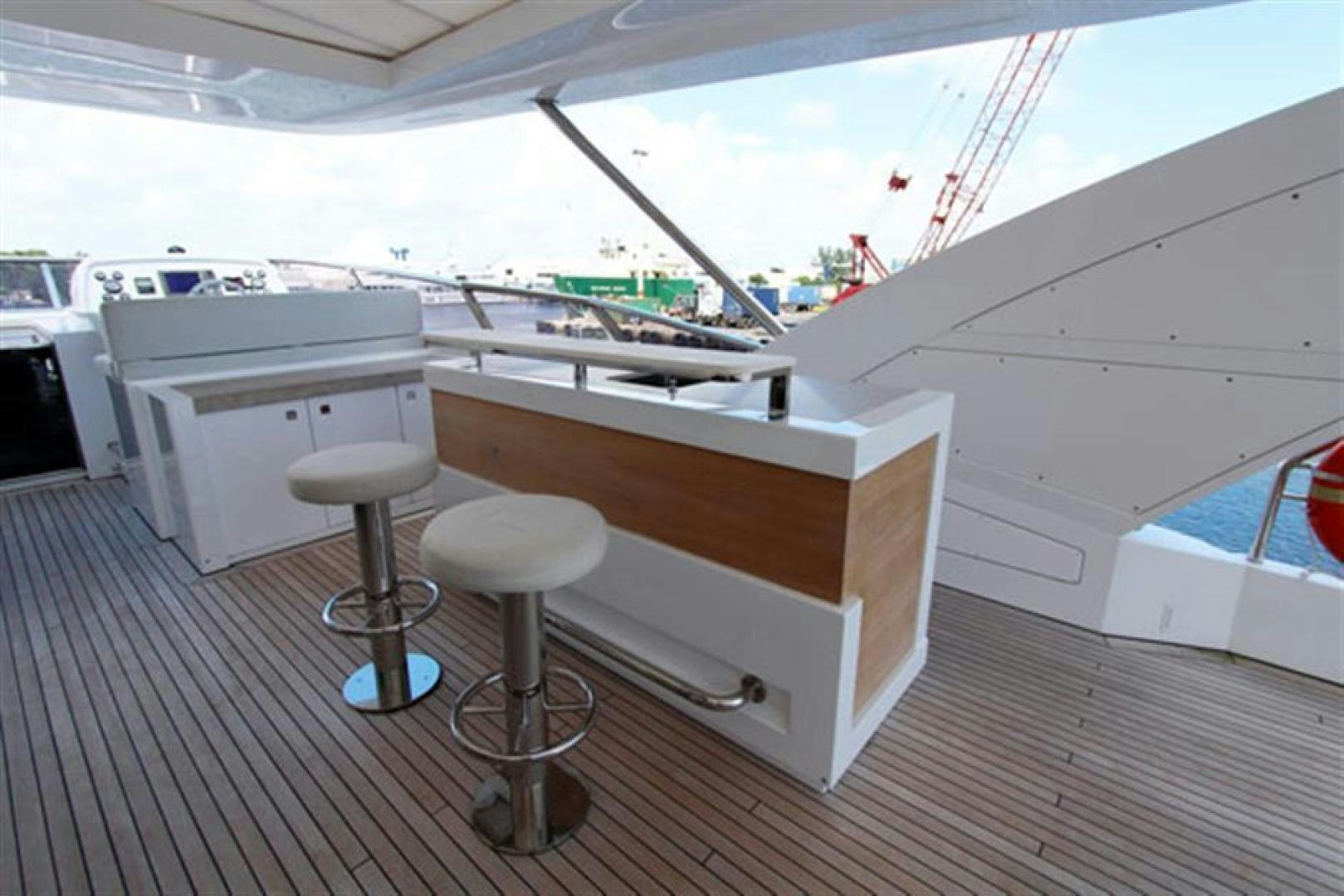 a white boat with stools aboard LA TACHE Yacht for Sale