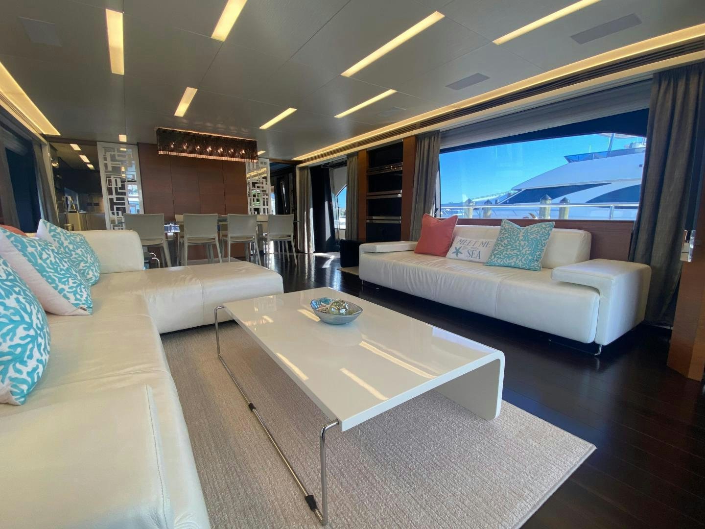 a living room with a couch and a coffee table aboard LA TACHE Yacht for Sale