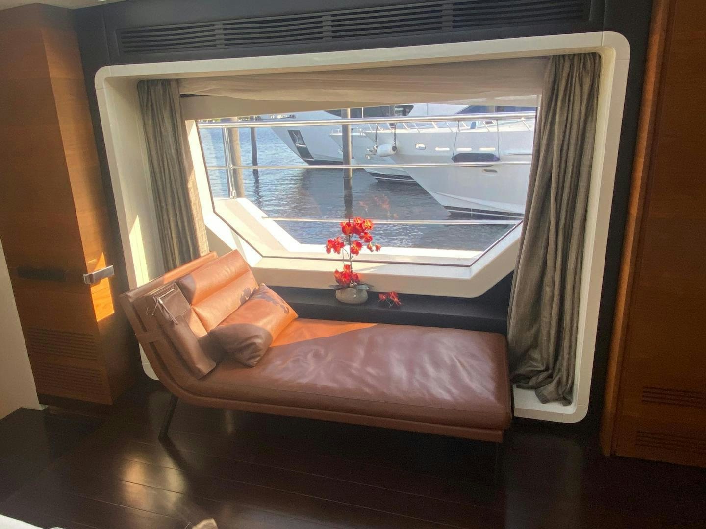 a person sleeping on a couch aboard LA TACHE Yacht for Sale