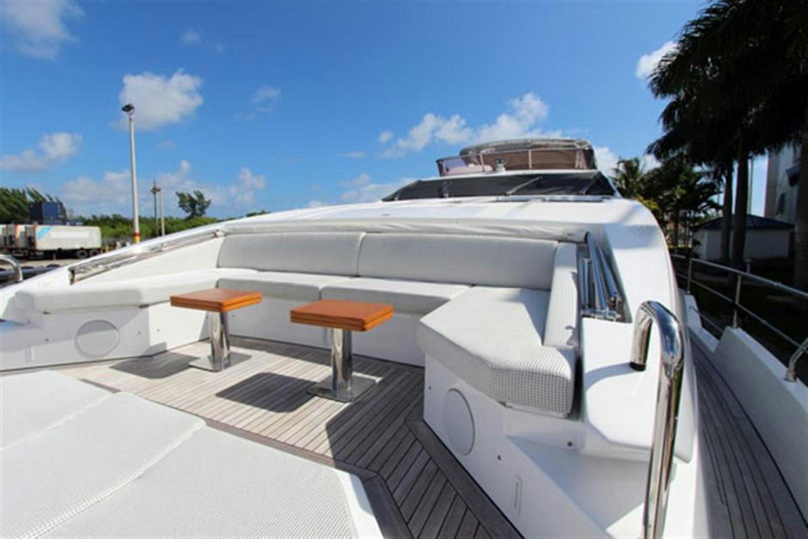 a white boat with a table and chairs on a deck aboard LA TACHE Yacht for Sale