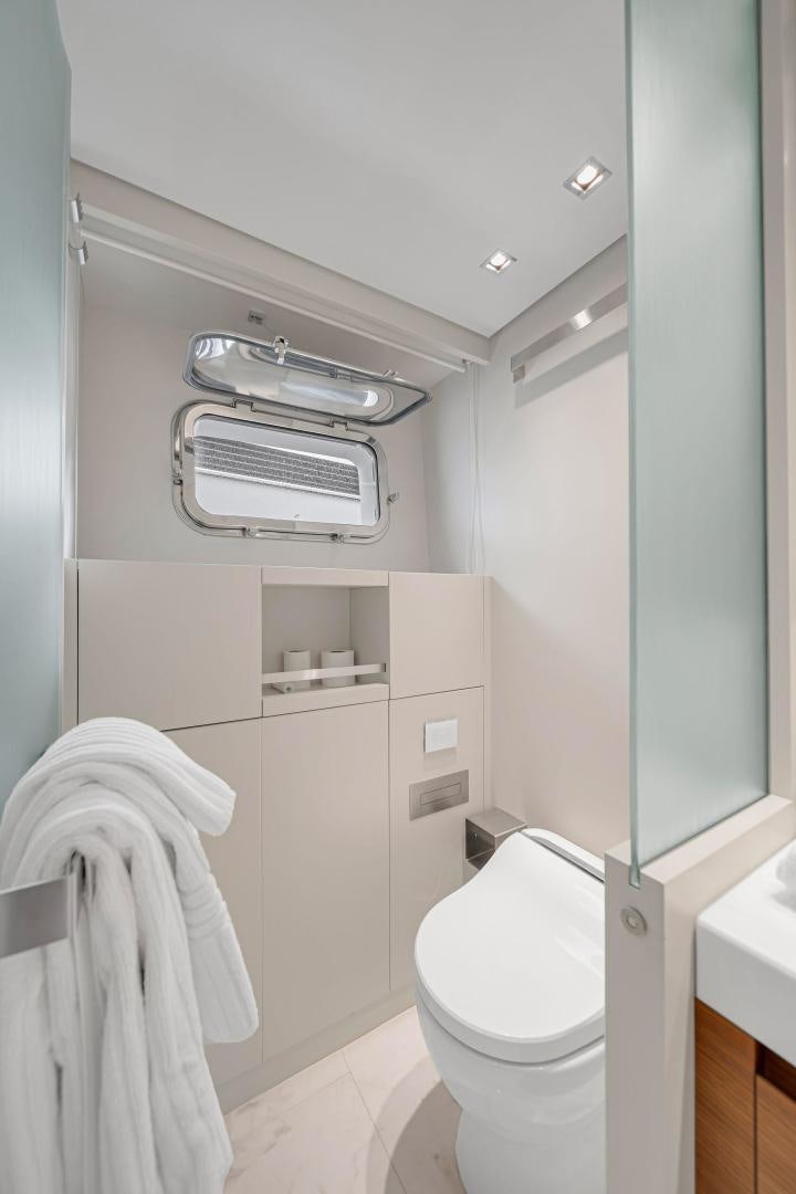 a bathroom with a toilet and sink aboard PEACEKEEPER Yacht for Sale