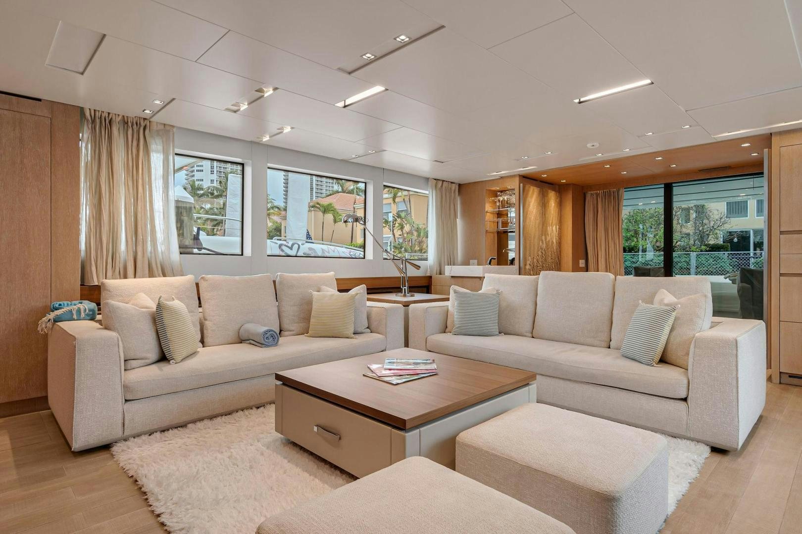 a living room with white couches aboard PEACEKEEPER Yacht for Sale