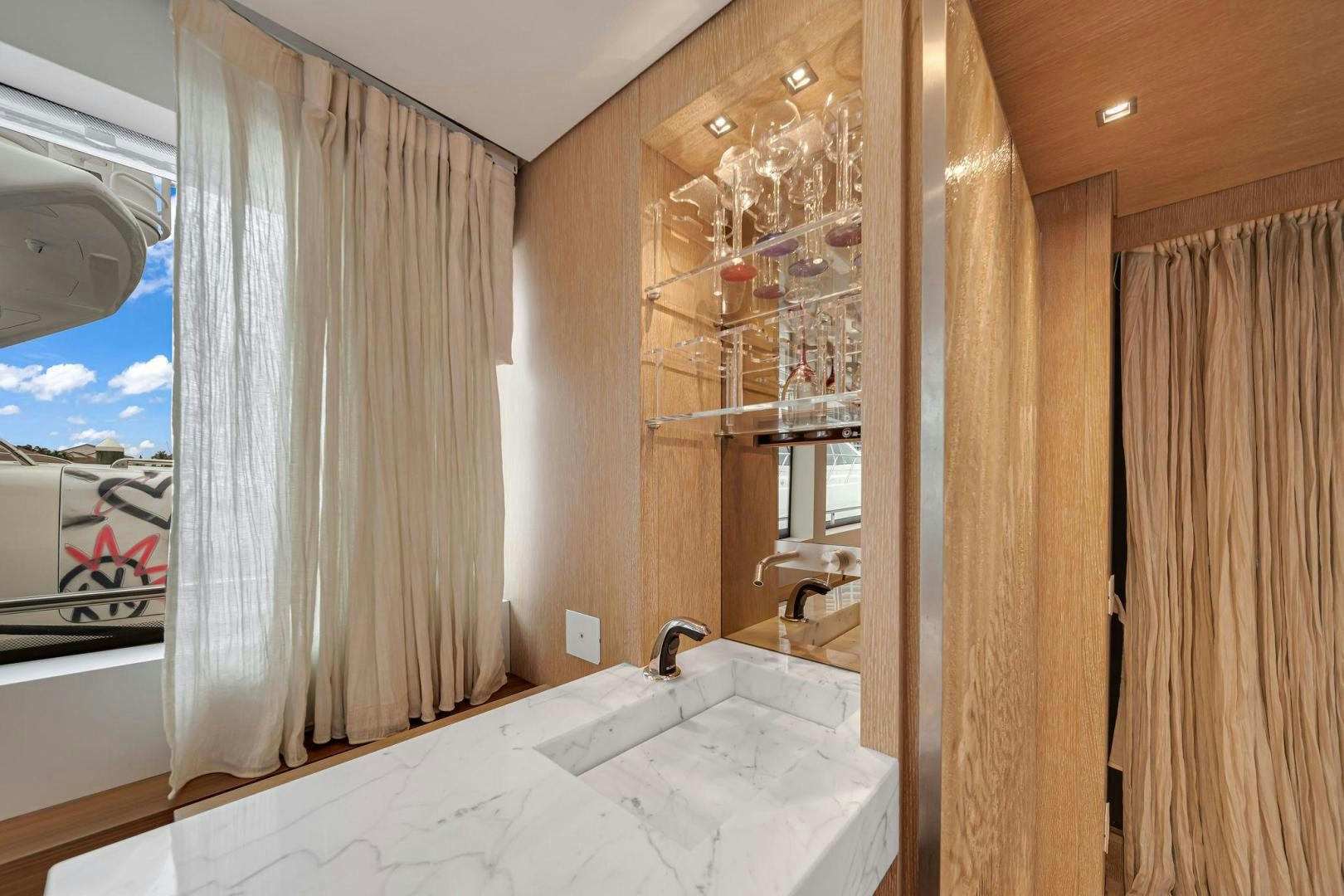 a bathroom with a large mirror aboard PEACEKEEPER Yacht for Sale