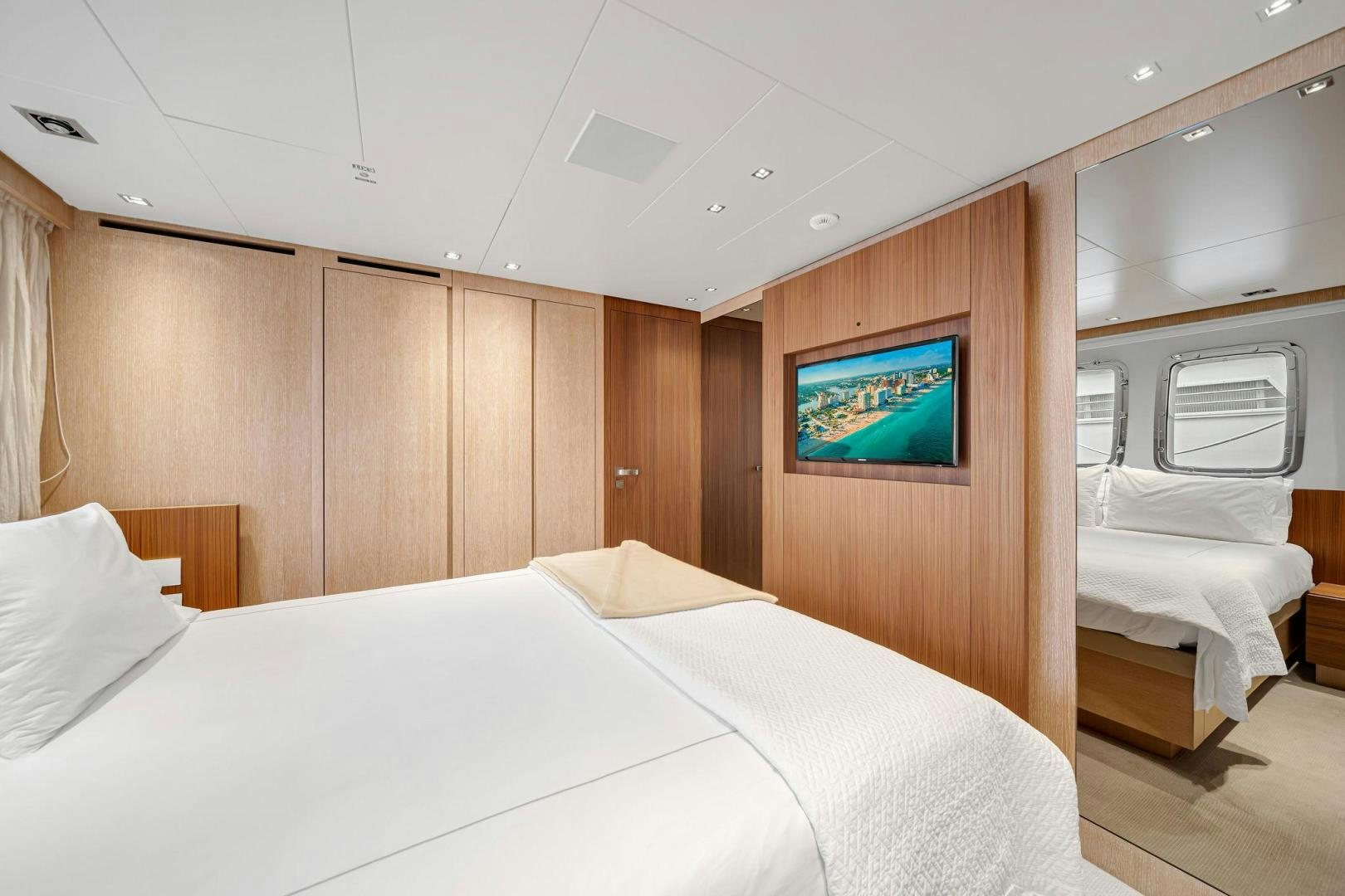 a room with a bed and a tv aboard PEACEKEEPER Yacht for Sale