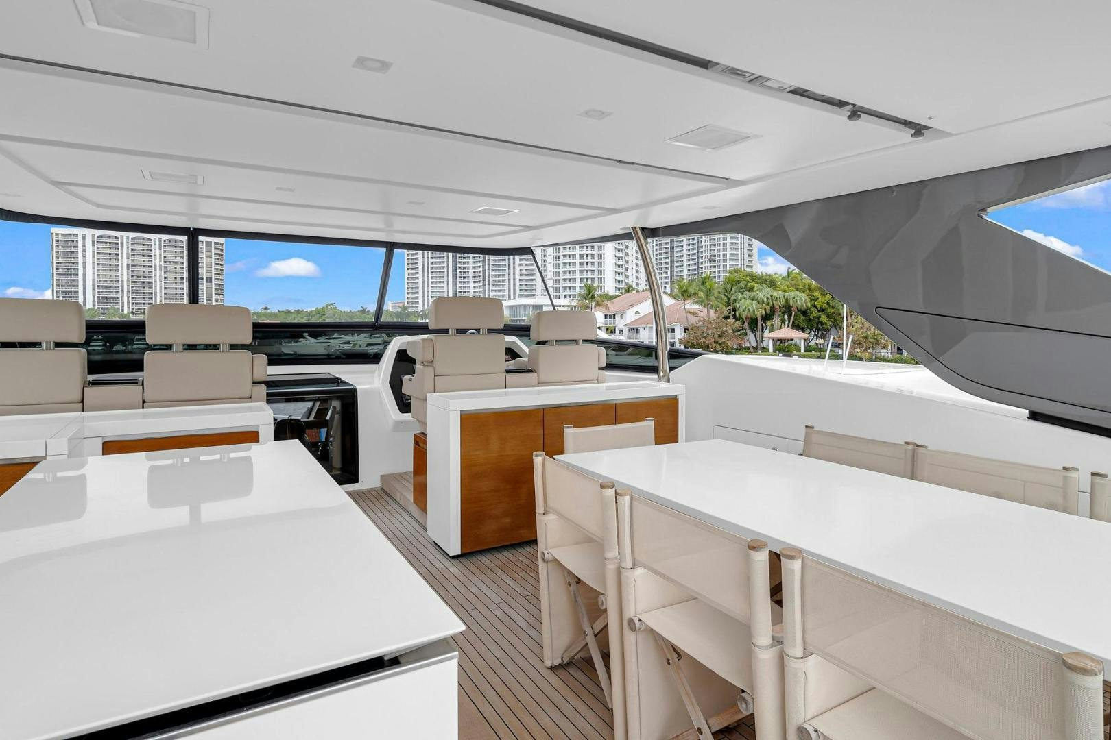 a room with tables and chairs aboard PEACEKEEPER Yacht for Sale