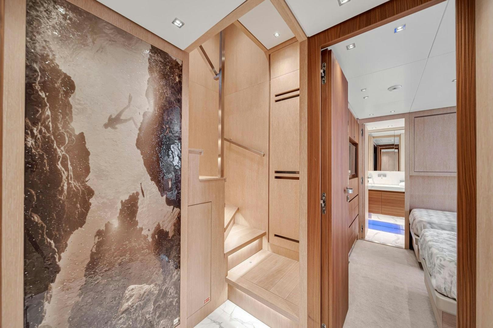 a room with a bed and a rock wall aboard PEACEKEEPER Yacht for Sale