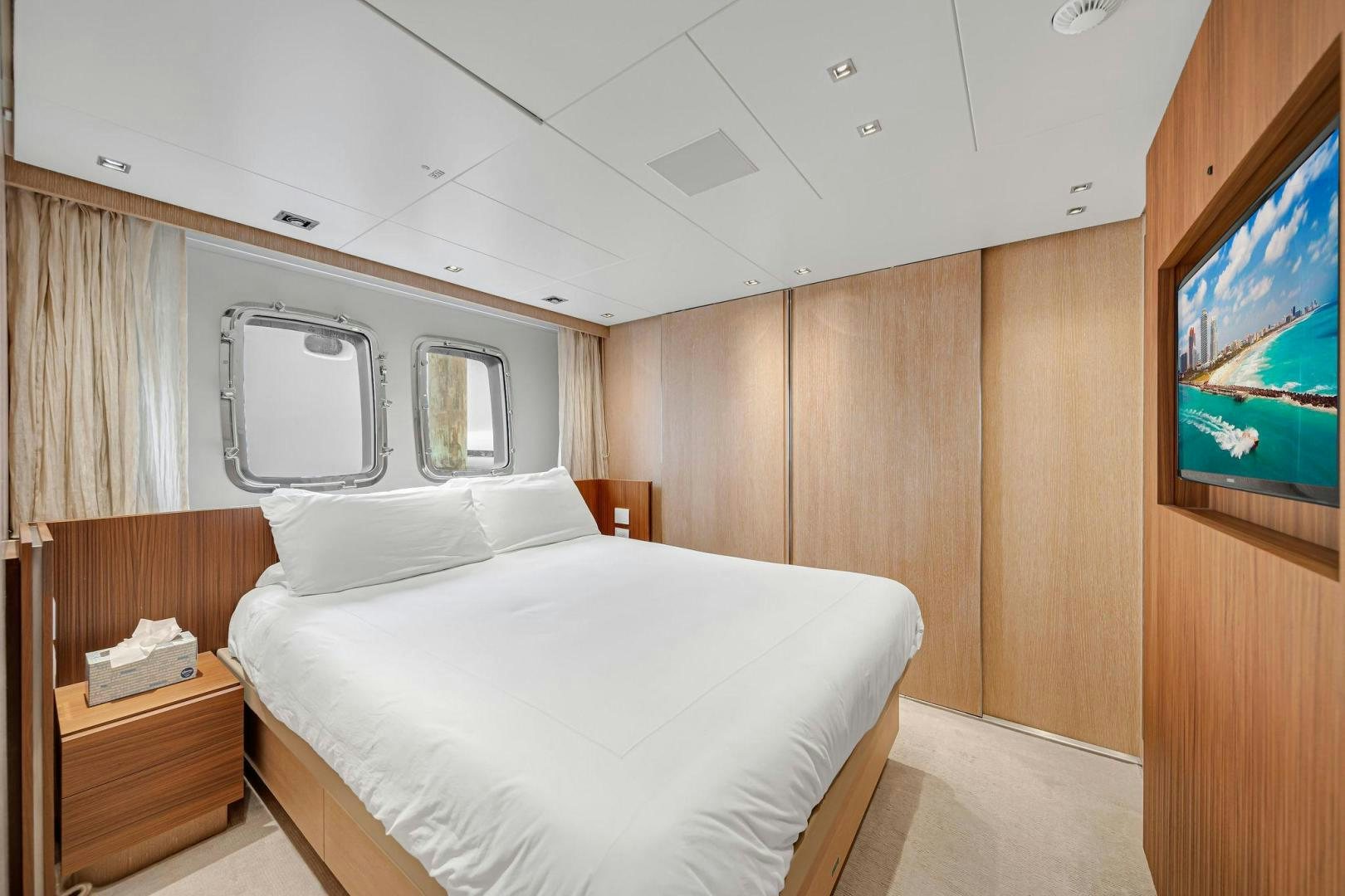 a room with a bed and a television aboard PEACEKEEPER Yacht for Sale