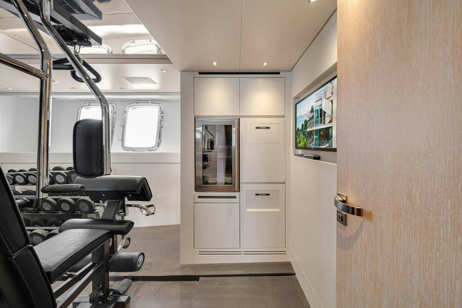 a room with a door and chairs aboard PEACEKEEPER Yacht for Sale