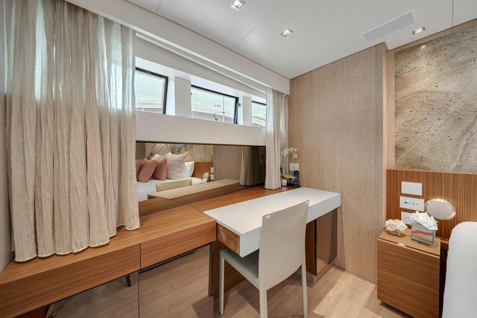 a room with a bed and desk aboard PEACEKEEPER Yacht for Sale