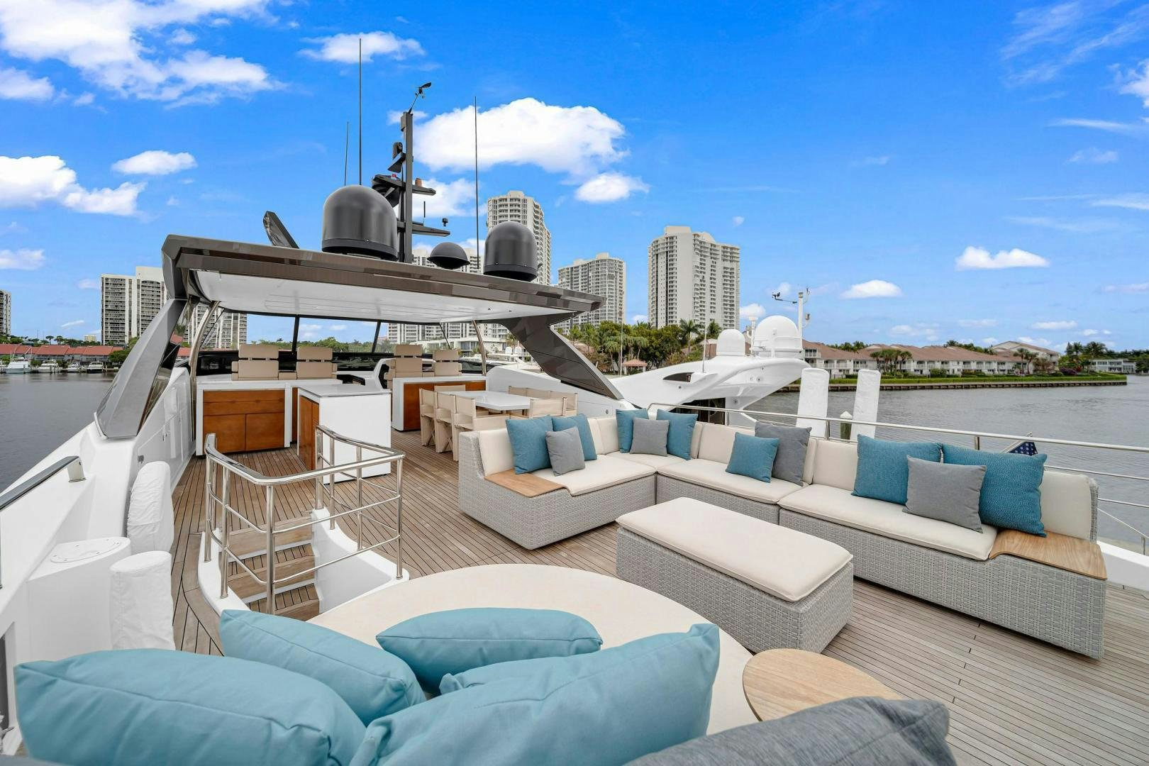 a rooftop with a lounge chair and a large building in the background aboard PEACEKEEPER Yacht for Sale