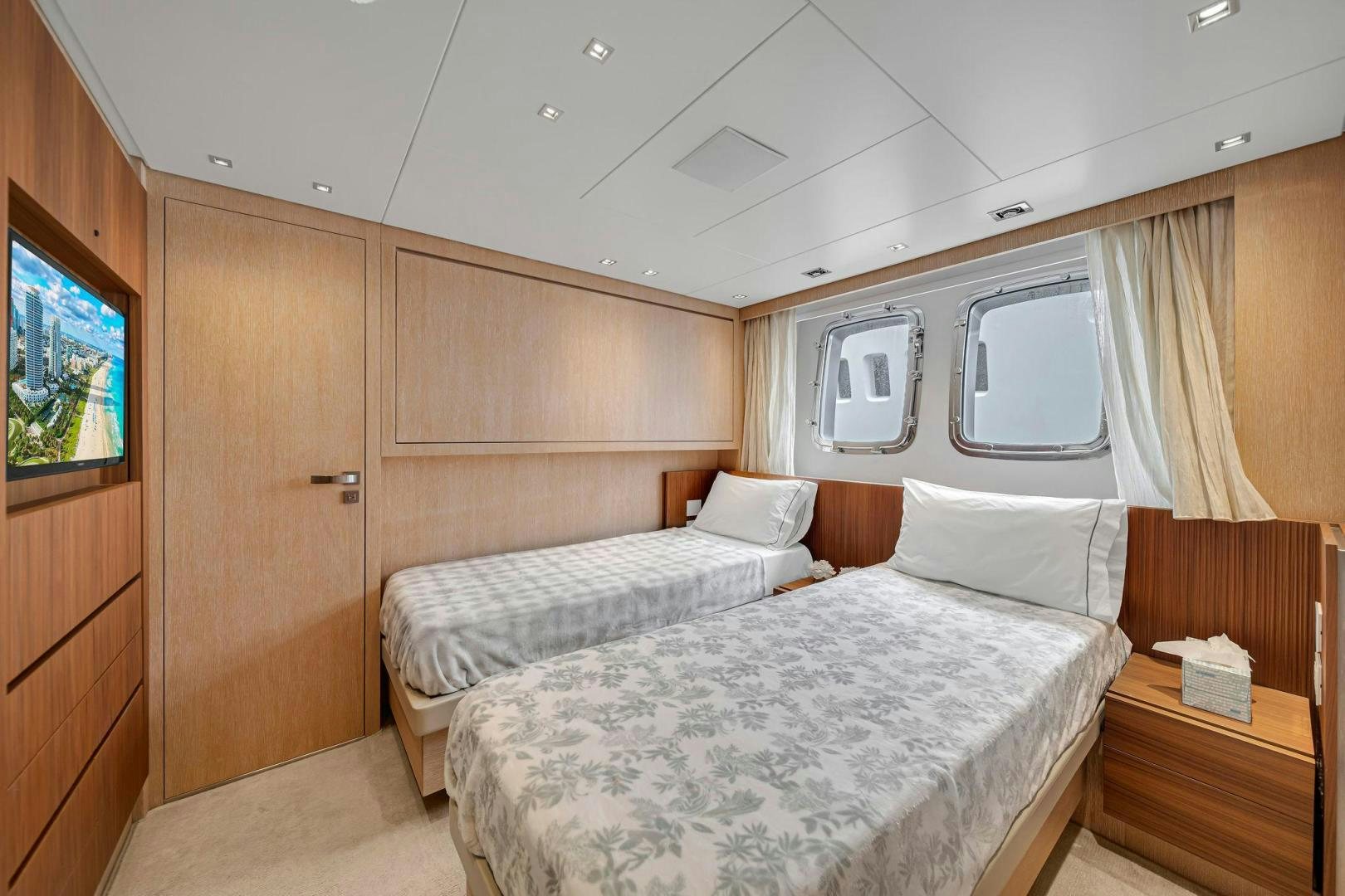 a room with a bed and a television aboard PEACEKEEPER Yacht for Sale