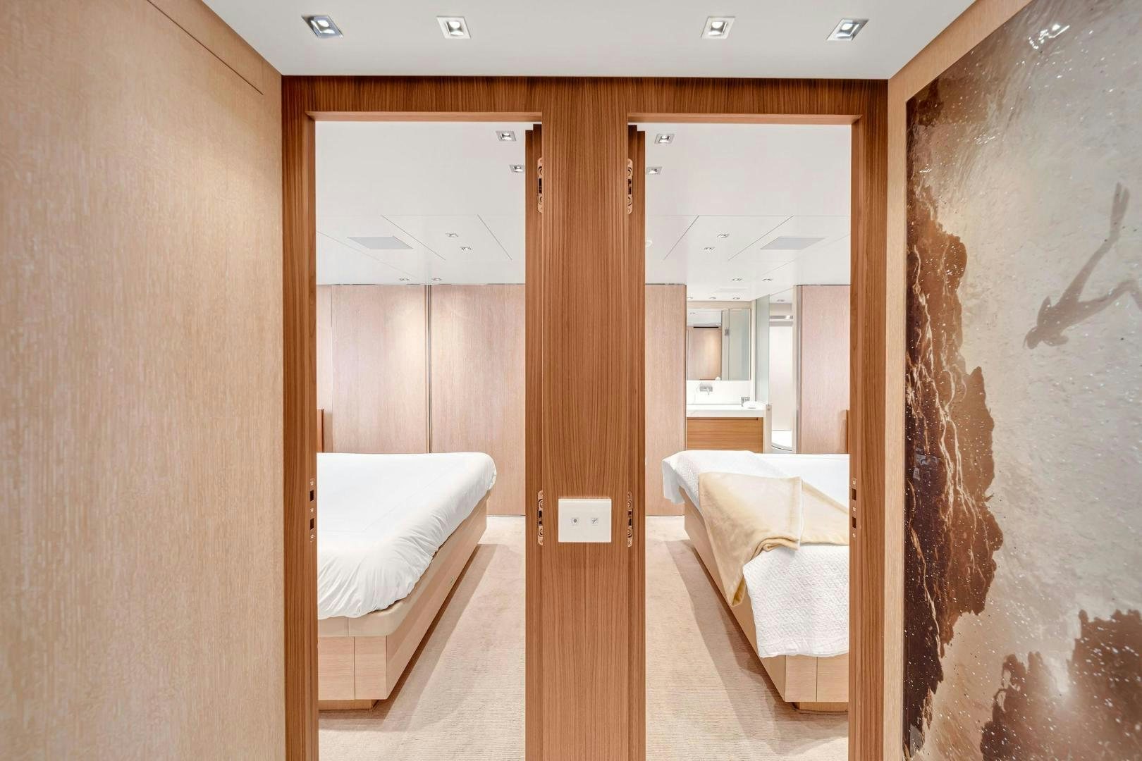 a room with a bed and a mirror aboard PEACEKEEPER Yacht for Sale