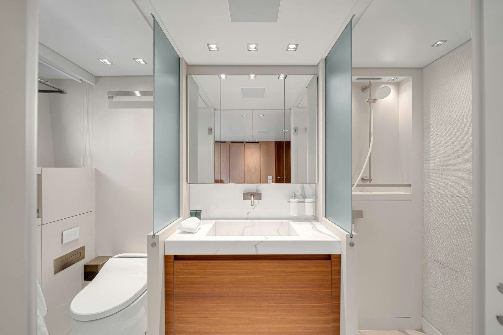 a bathroom with a large mirror aboard PEACEKEEPER Yacht for Sale