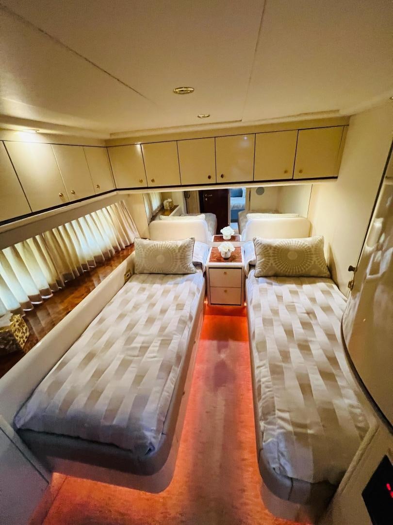 a room with a bed and a table aboard MAGIC MOMENTS Yacht for Sale