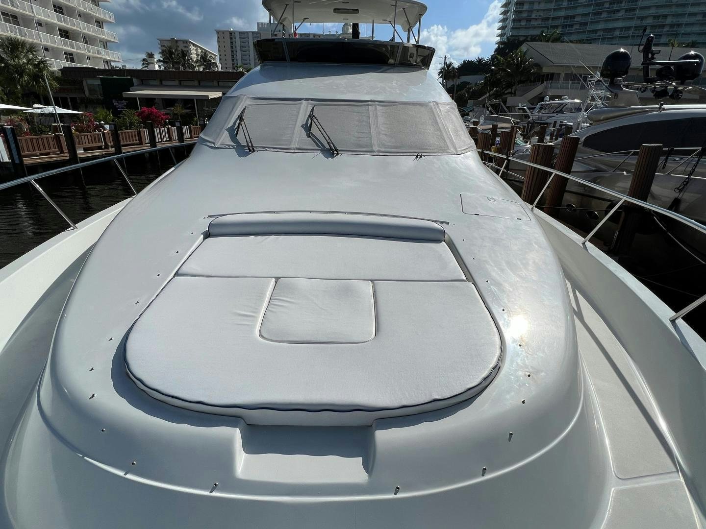 a white yacht in a harbor aboard MAGIC MOMENTS Yacht for Sale