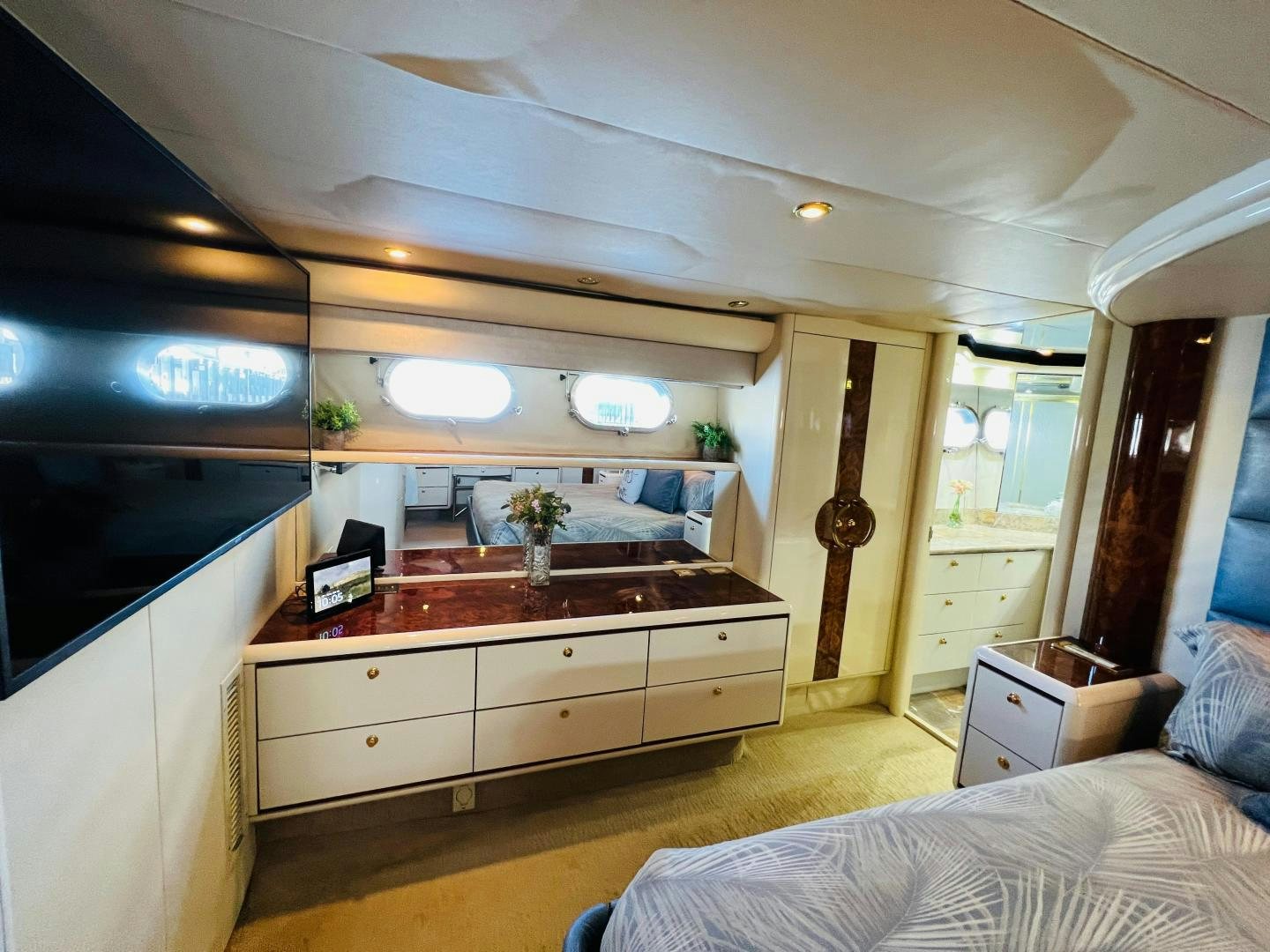 a bedroom with a bed and a desk aboard MAGIC MOMENTS Yacht for Sale