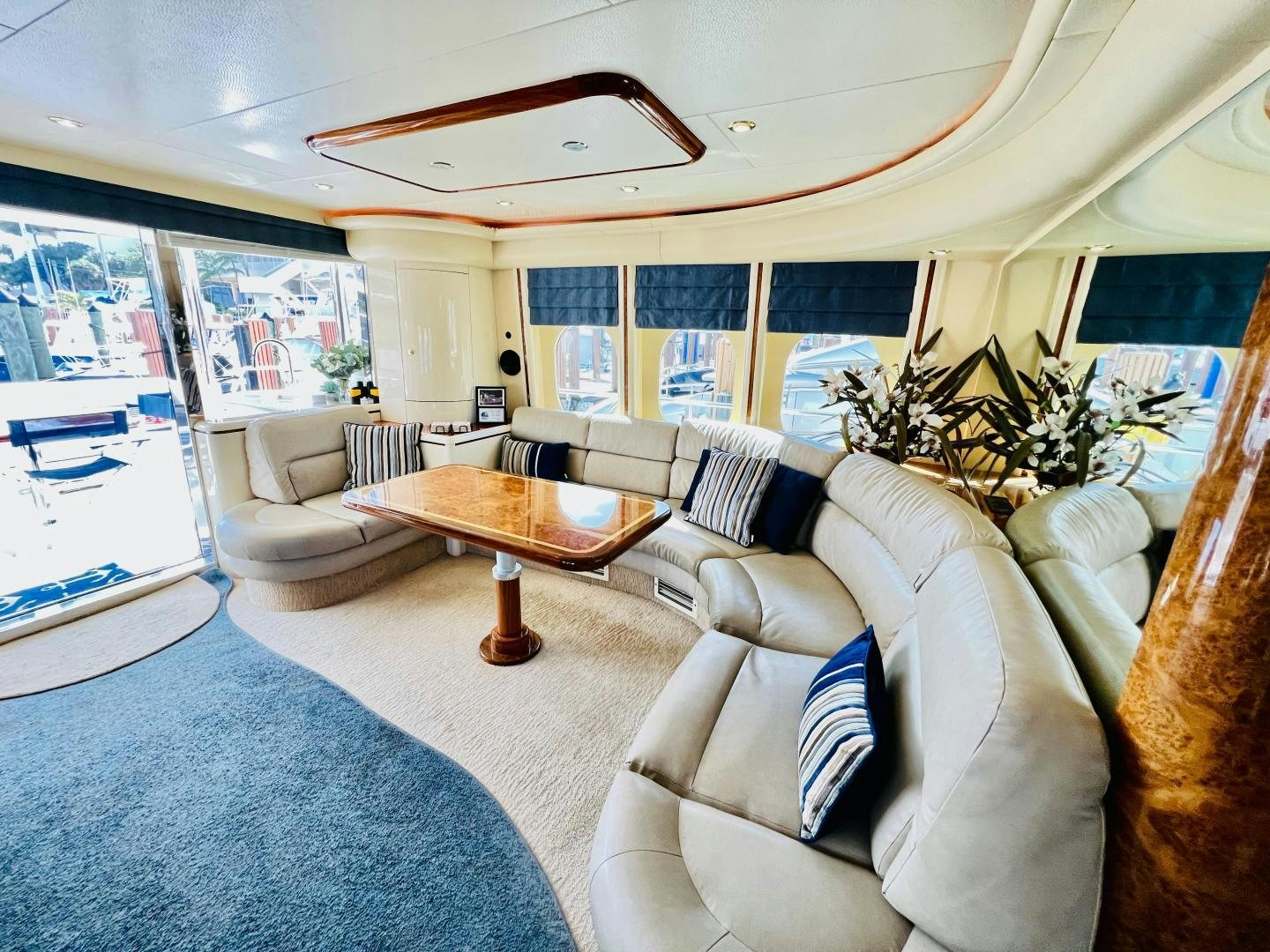 a living room with a table and couches aboard MAGIC MOMENTS Yacht for Sale