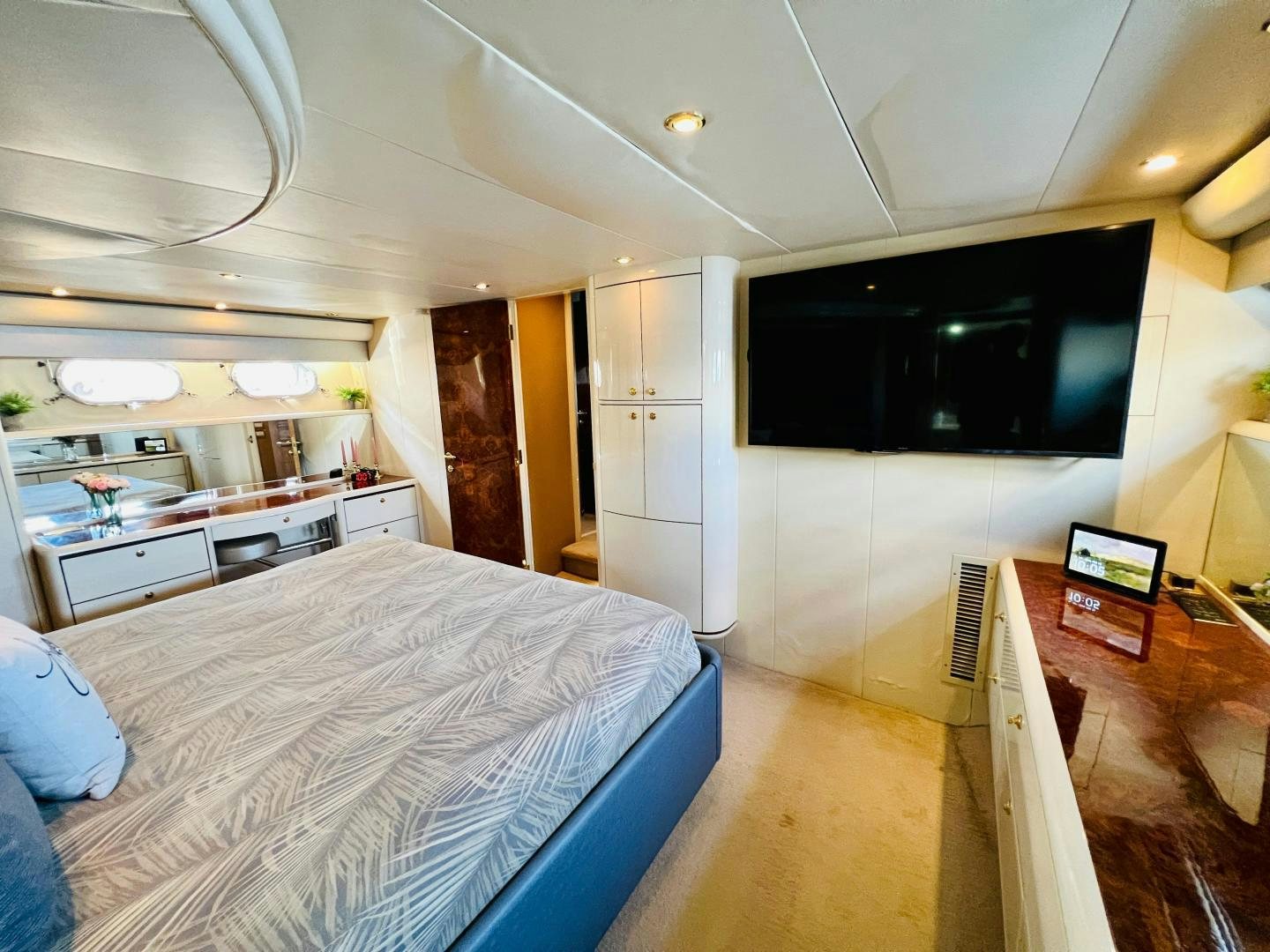 a bedroom with a bed and a tv aboard MAGIC MOMENTS Yacht for Sale