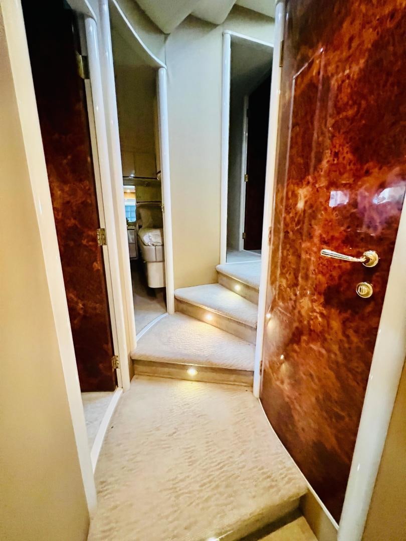 a hallway with a red wall aboard MAGIC MOMENTS Yacht for Sale