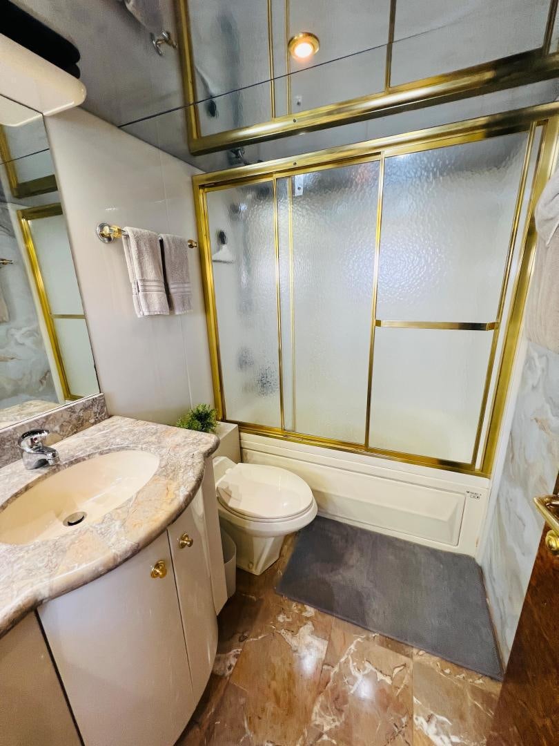 a bathroom with a toilet and sink aboard MAGIC MOMENTS Yacht for Sale