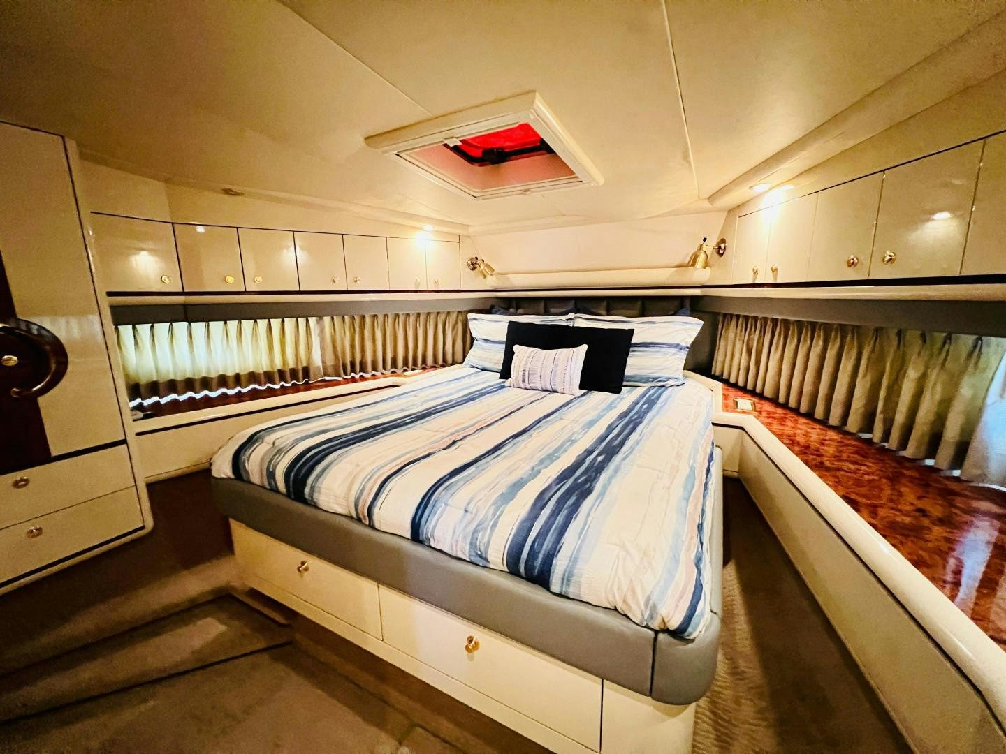 a room with a bed and a window aboard MAGIC MOMENTS Yacht for Sale