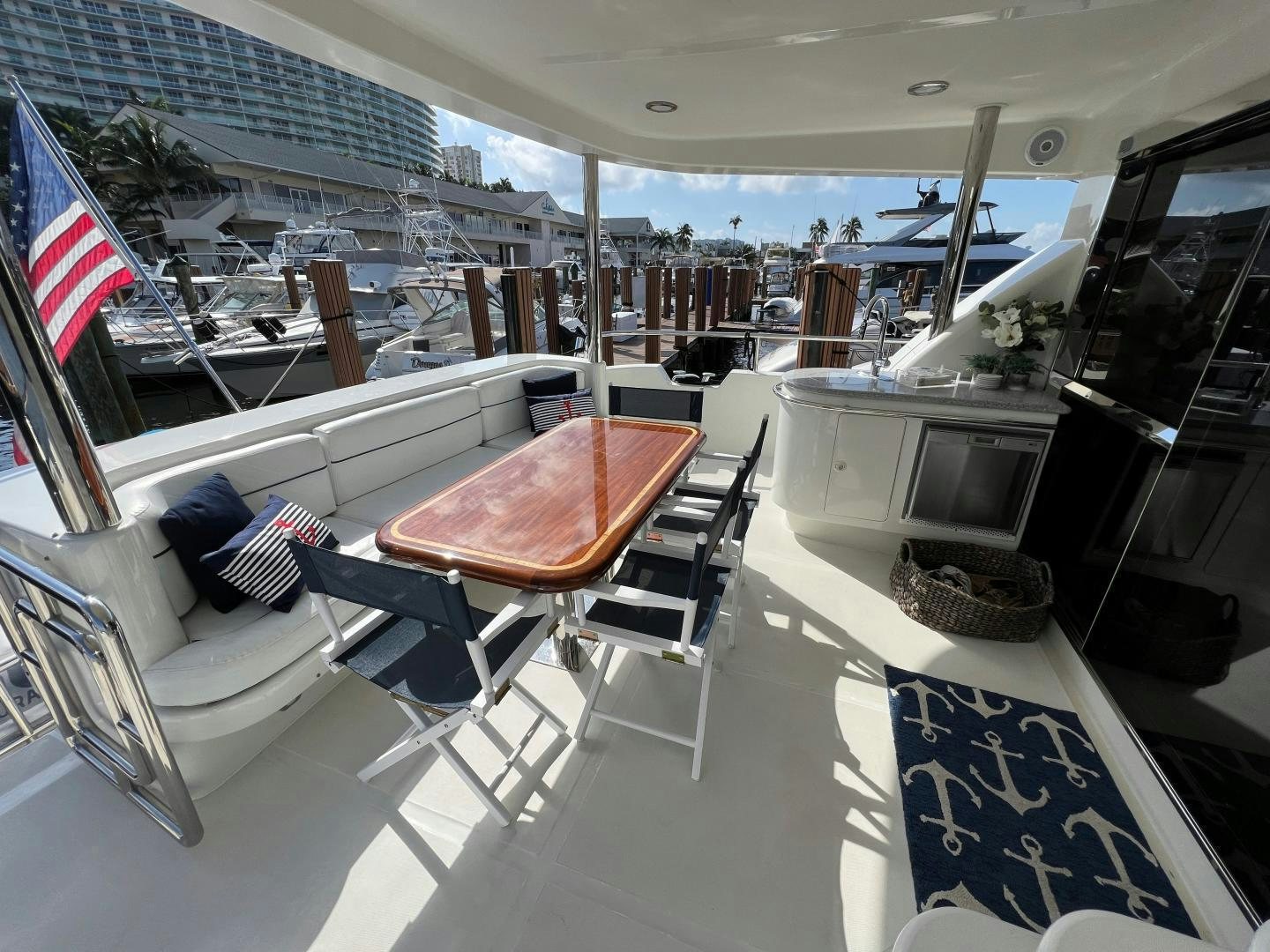 a deck with a table and chairs aboard MAGIC MOMENTS Yacht for Sale