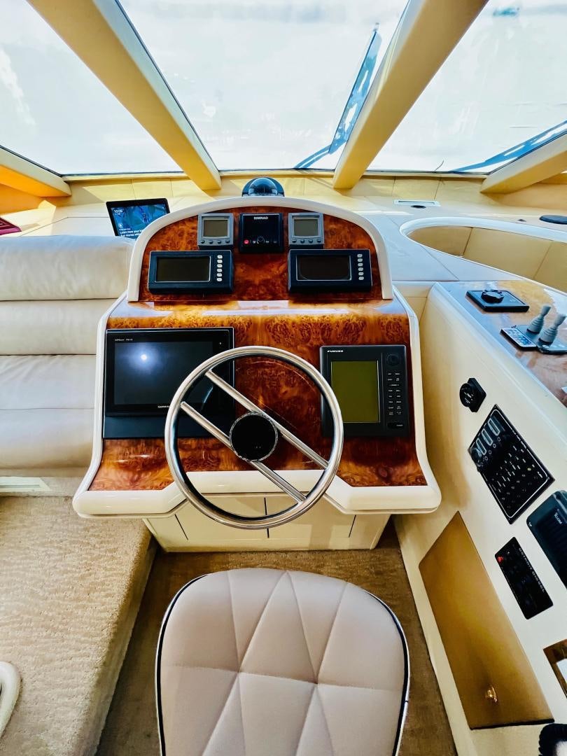 a table with a laptop and other objects on it aboard MAGIC MOMENTS Yacht for Sale