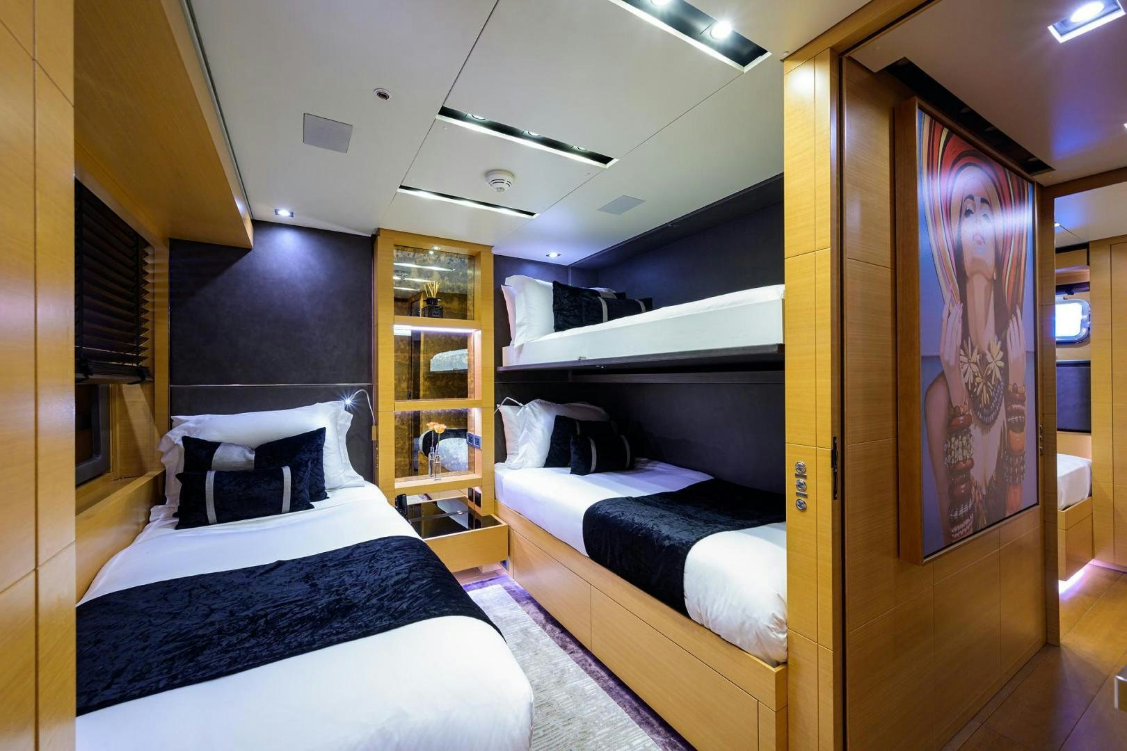 a room with a bed and a cabinet aboard AWAY Yacht for Sale