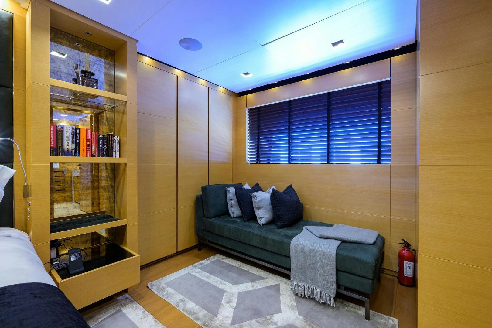 a room with a bed and a bookcase aboard AWAY Yacht for Sale