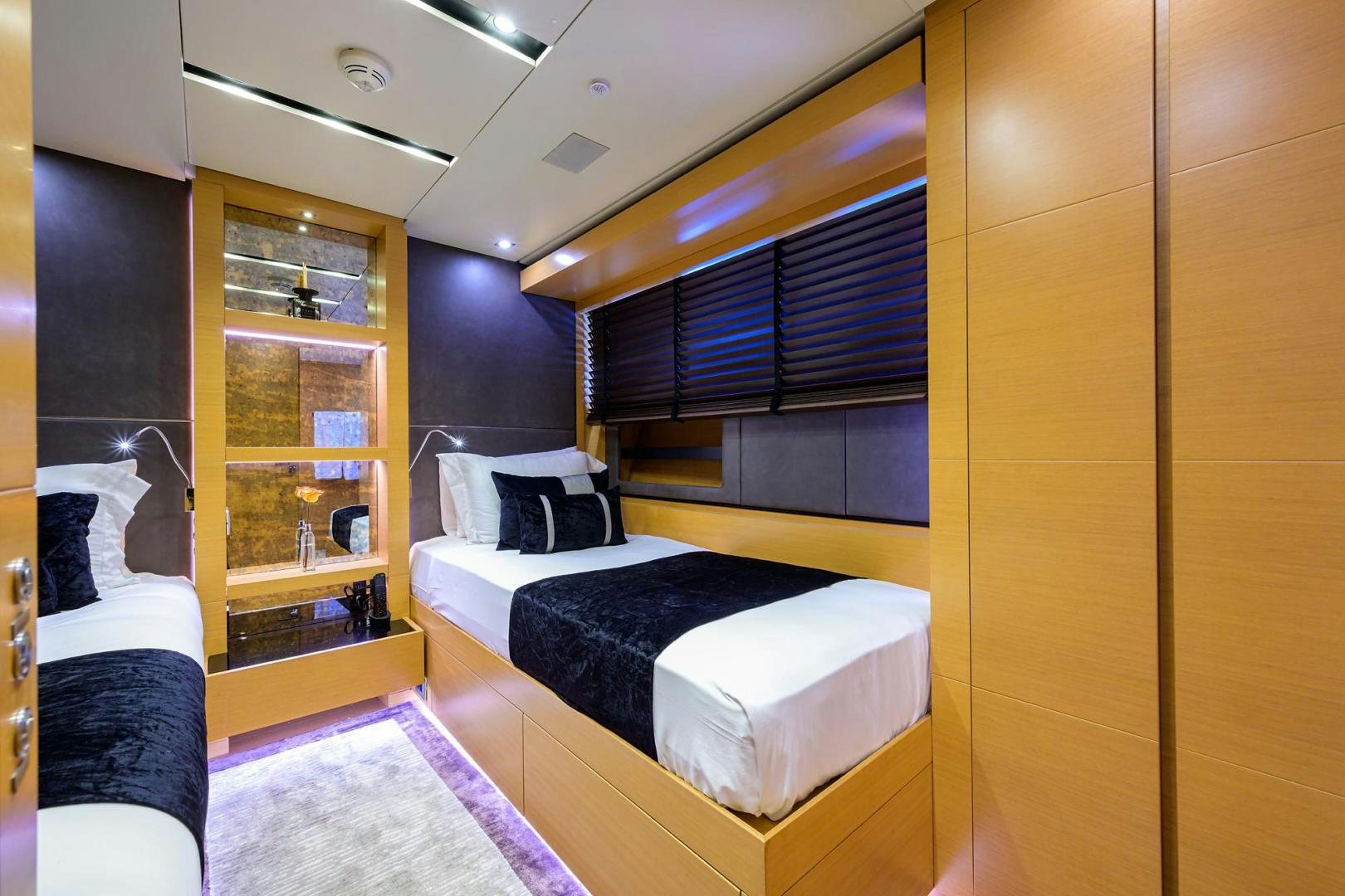 a room with a bed and a shelf with bookshelves aboard AWAY Yacht for Sale