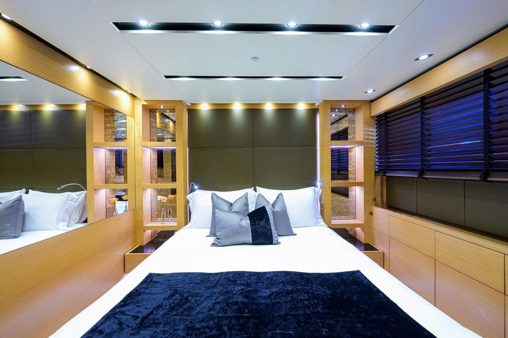 a room with a bed and a bookcase aboard AWAY Yacht for Sale